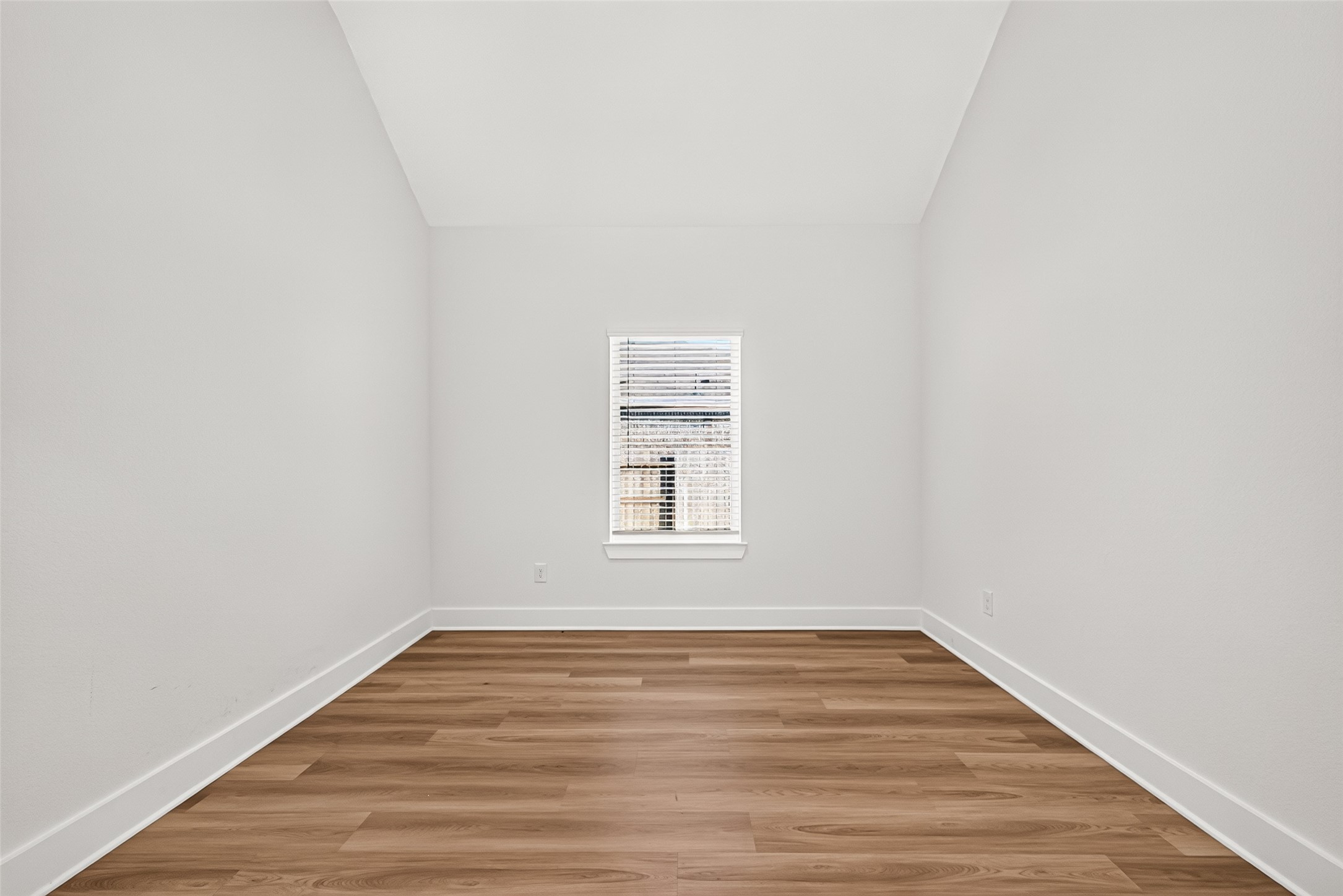Front flex room with vaulted ceiling, wood-look flooring, and natural light. Can be used as an office, den, or dining room. Front flex room with vaulted ceiling, wood-look flooring, and natural light. Can be used as an office, den, or dining room.