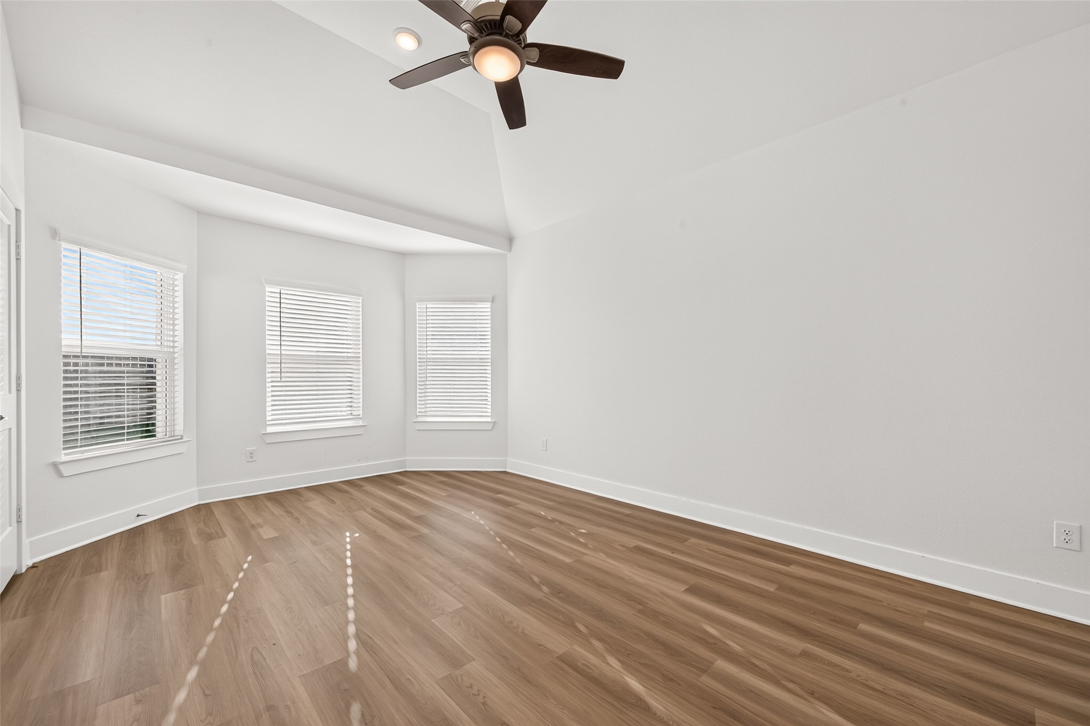 Primary bedroom bay window with three windows bringing in natural light.