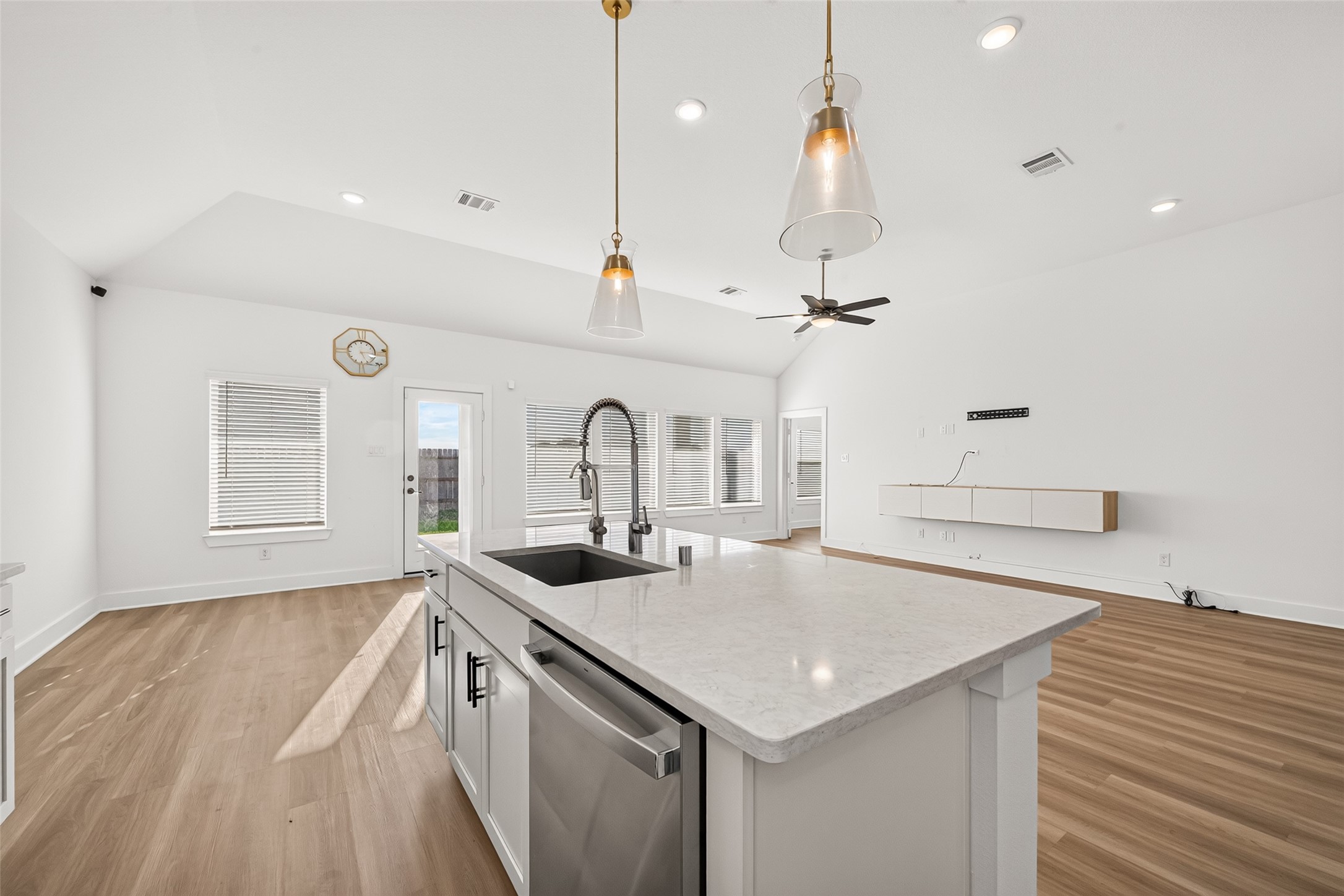 Kitchen island with sink and dishwasher, open to the breakfast area and living room.