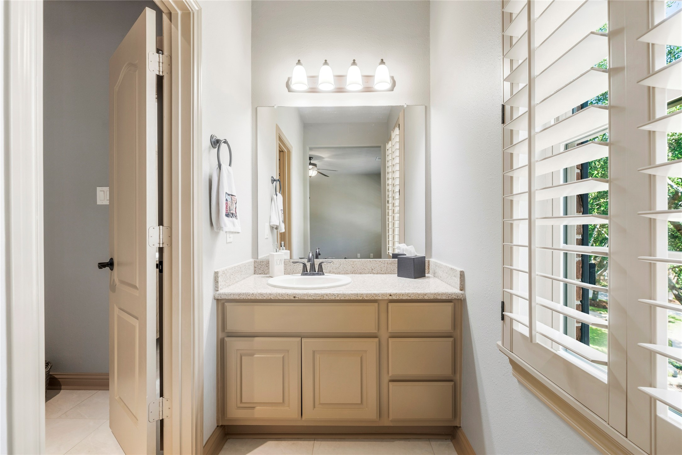 Bright bathroom vanity area featuring a large , and natural light.