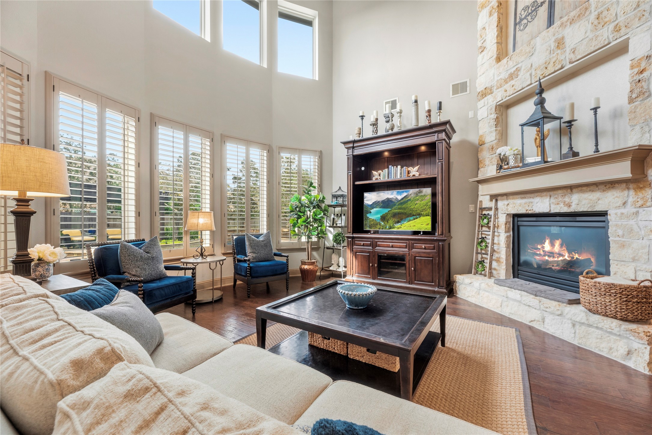 Another view of the spacious living room, highlighting the fireplace.