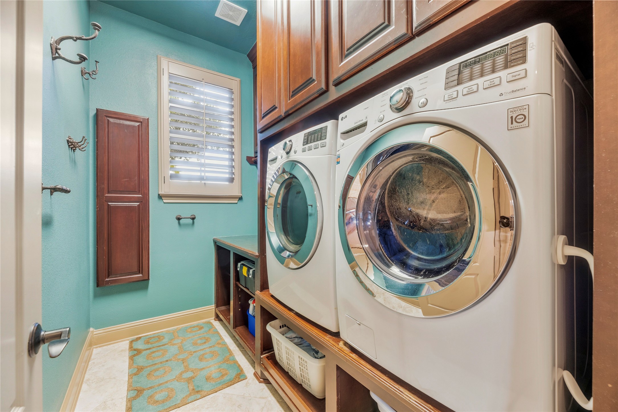 Laundry room featuring built-in cabinetry, counter space, and plenty of storage for everyday essentials.