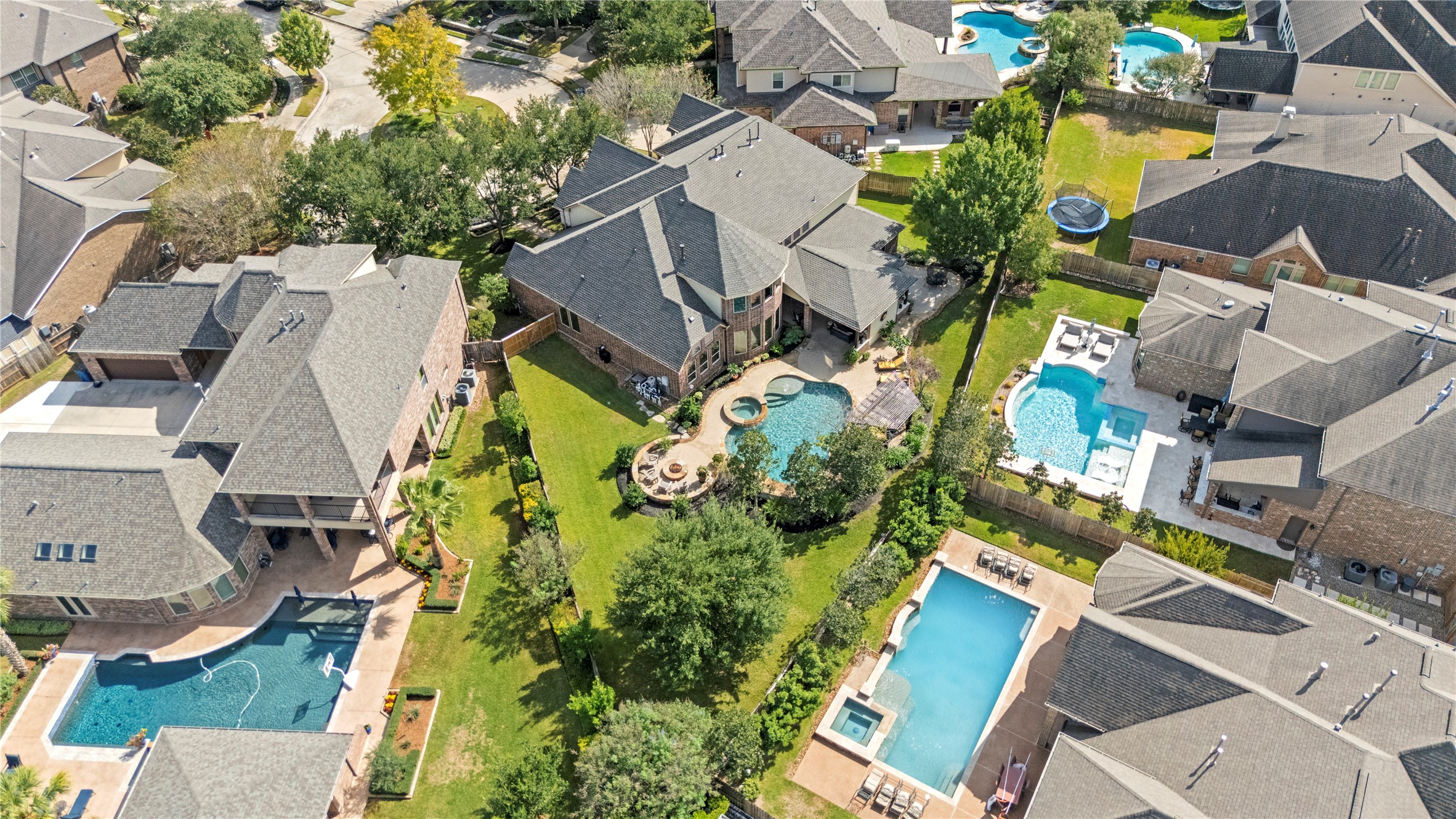 Surrounding neighborhood, showcasing the spacious properties and beautiful backyard settings.