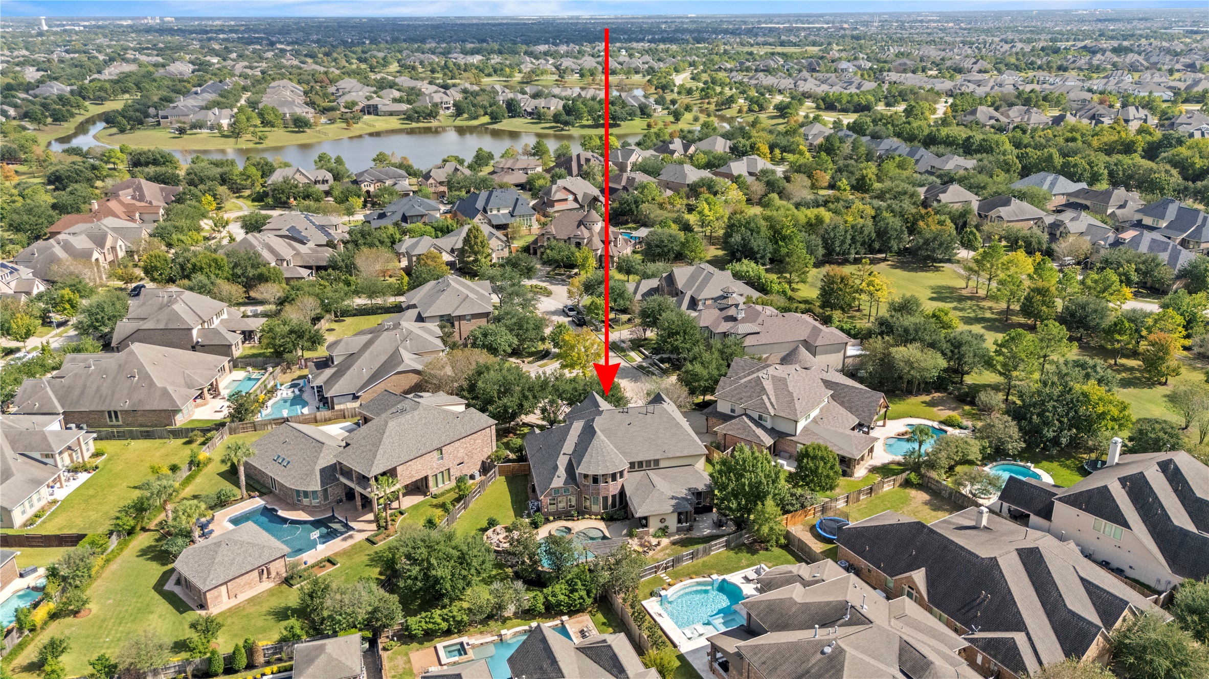 Wide aerial view highlighting the home's location and the surrounding residential community.