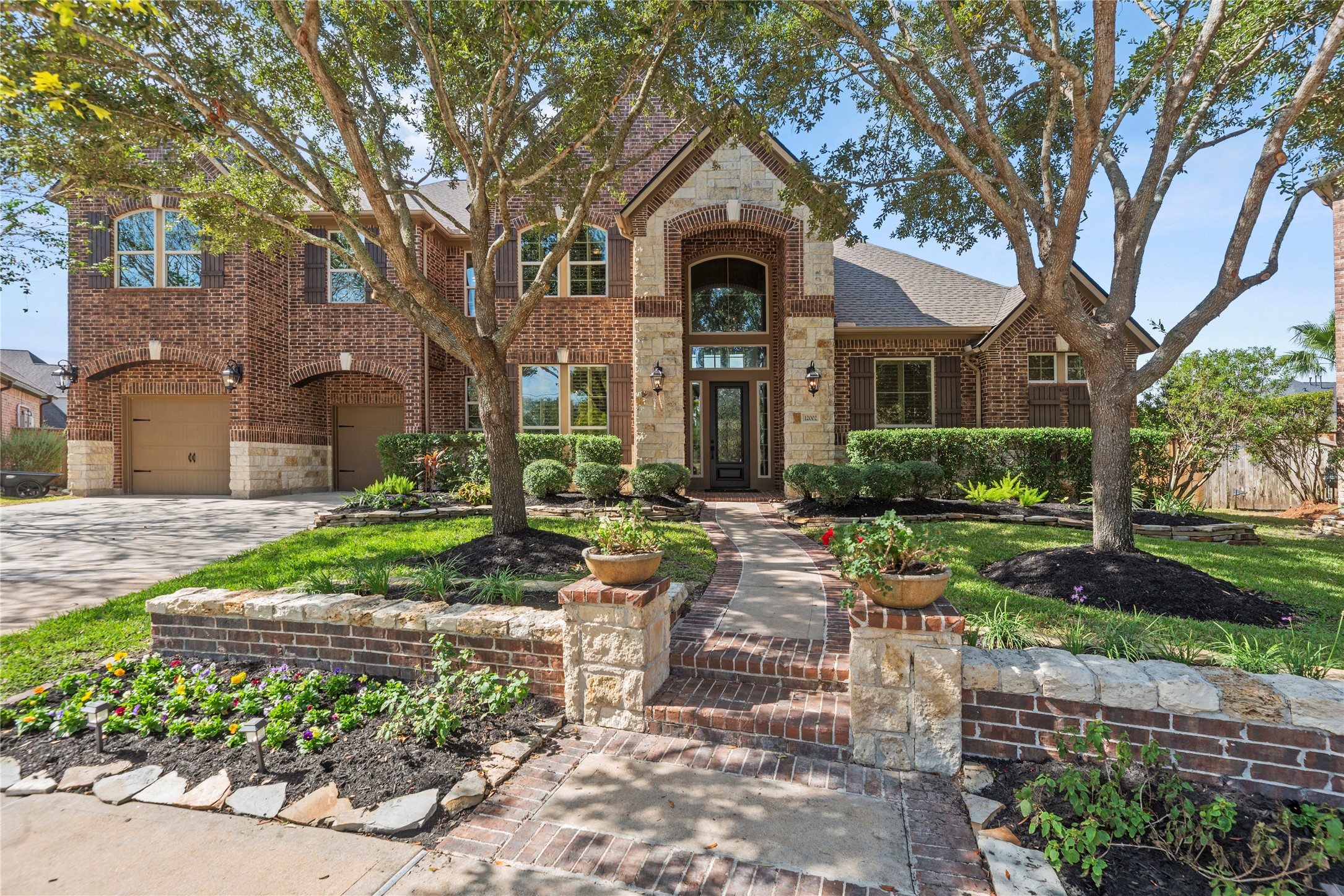 Welcoming front entrance surrounded by lush landscaping, mature trees, and a charming walkway. Welcoming front entrance surrounded by lush landscaping, mature trees, and a charming walkway.