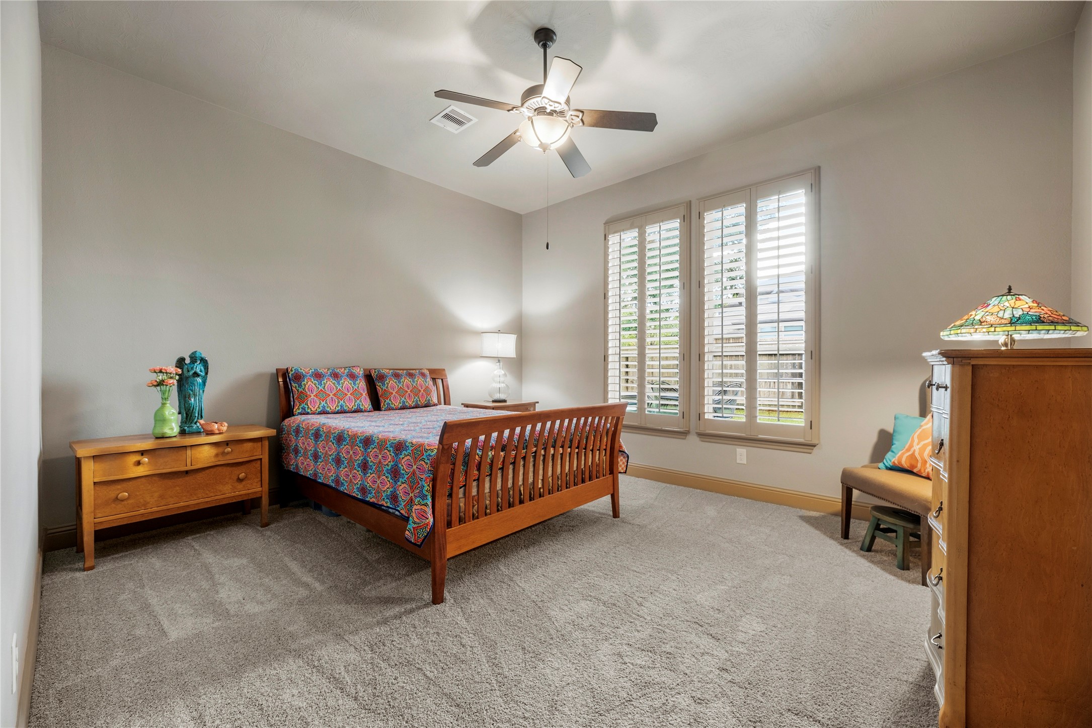 Bedroom 2 downstairs. Its a generous size featuring a ceiling fan and a large closet.