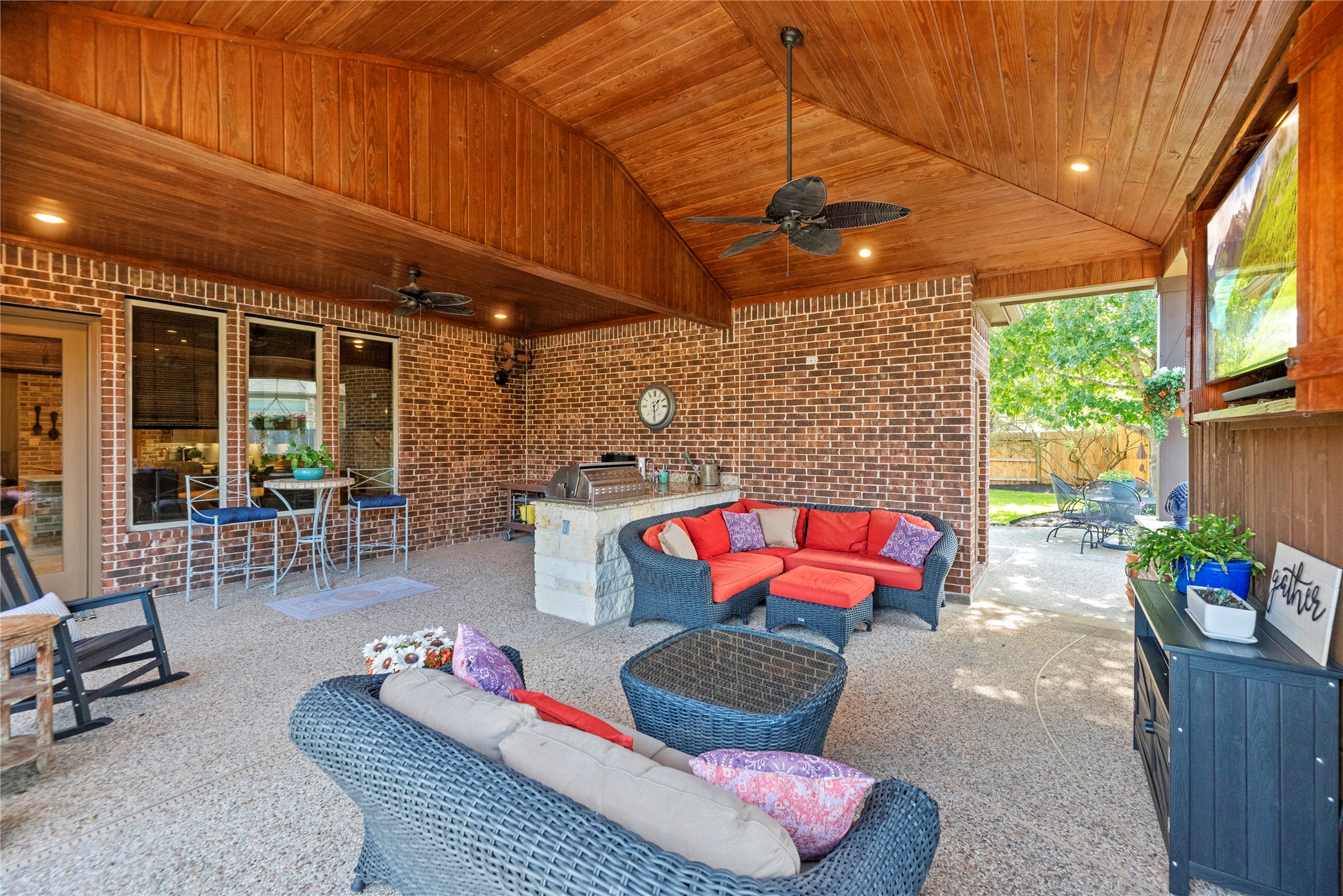 Another view of the covered patio, highlighting the generous seating space and inviting outdoor atmosphere.