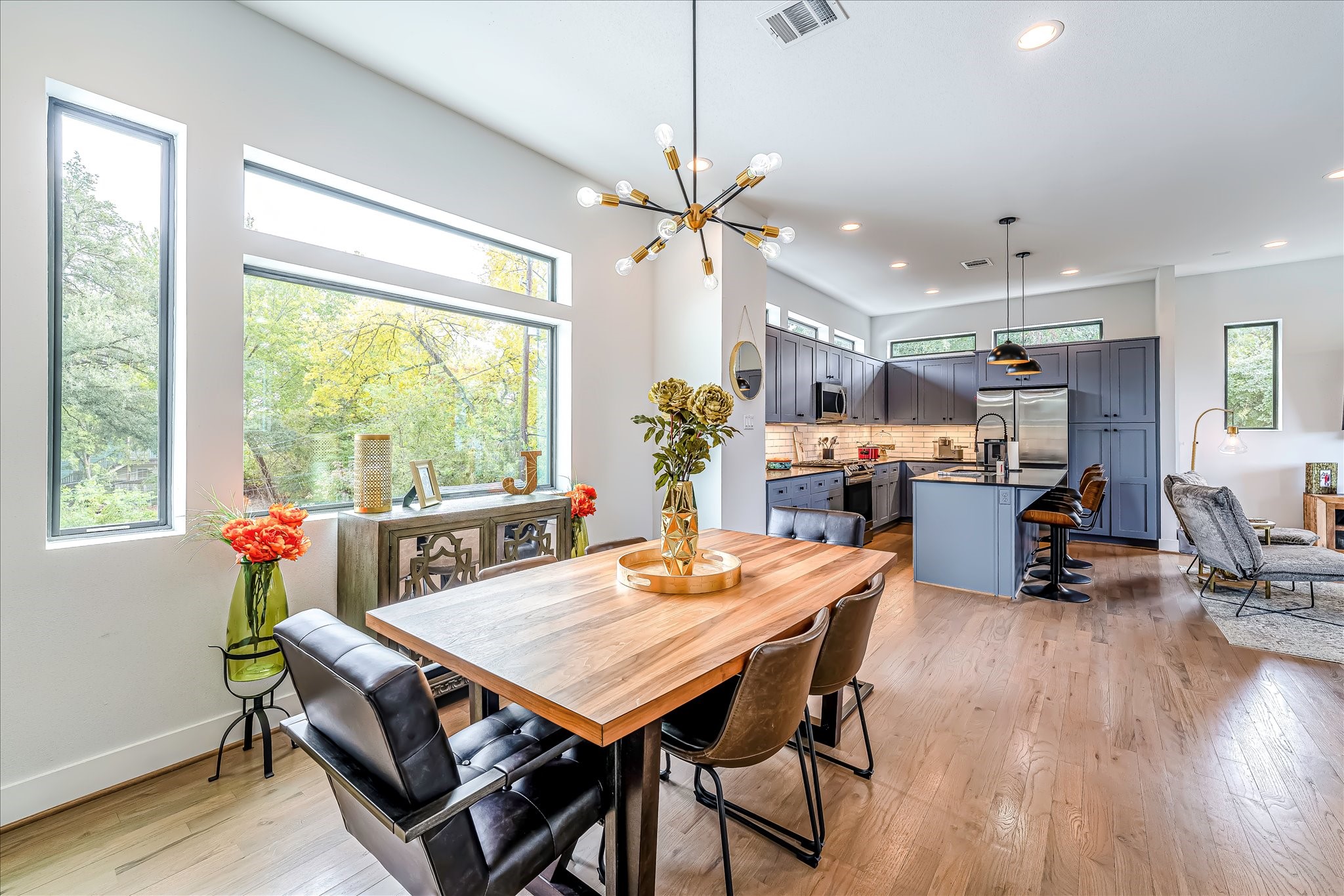 Designer lighting and contemporary finishes complement the home's modern architecture. Photos reflect previous furnishings. Home is currently vacant. Furnishings shown are for illustrative purposes only.