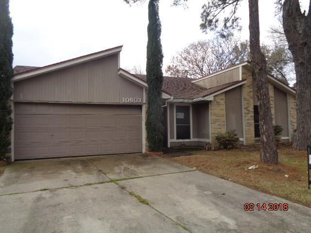 Single-story home with a two-car garage, front yard with mature trees