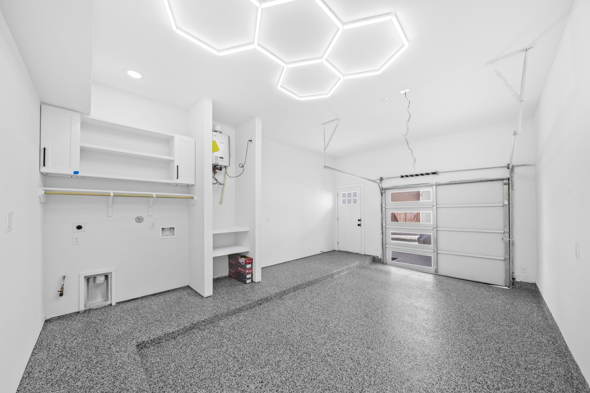 Epoxy finished garage floors and custom lighting. All laundry areas feature built in cabinets and shelves.