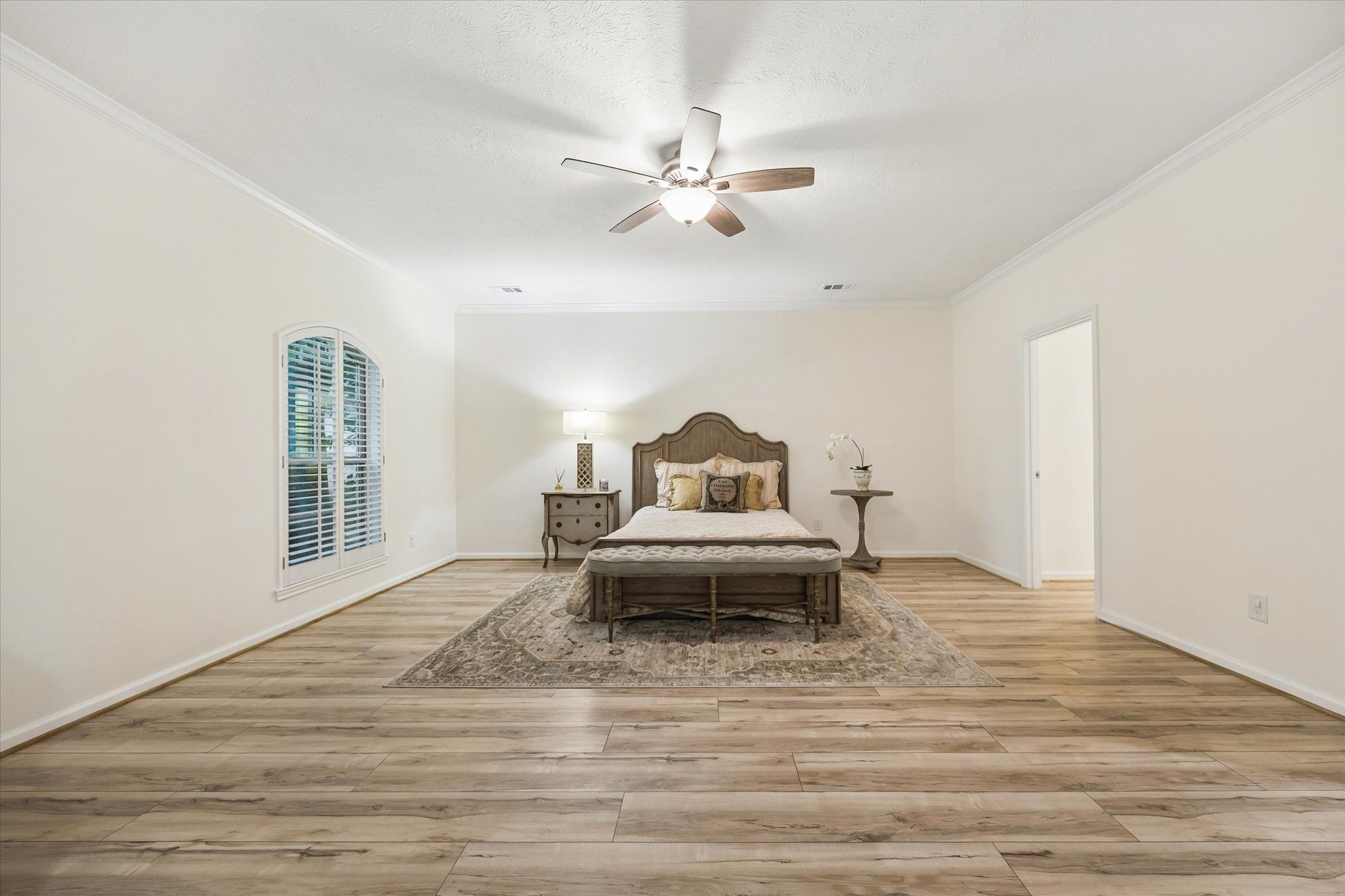 SPACIOUS PRIMARY BEDROOM WITH PLENTY OF ROOM FOR A COMFORTABLE SITTING AREA