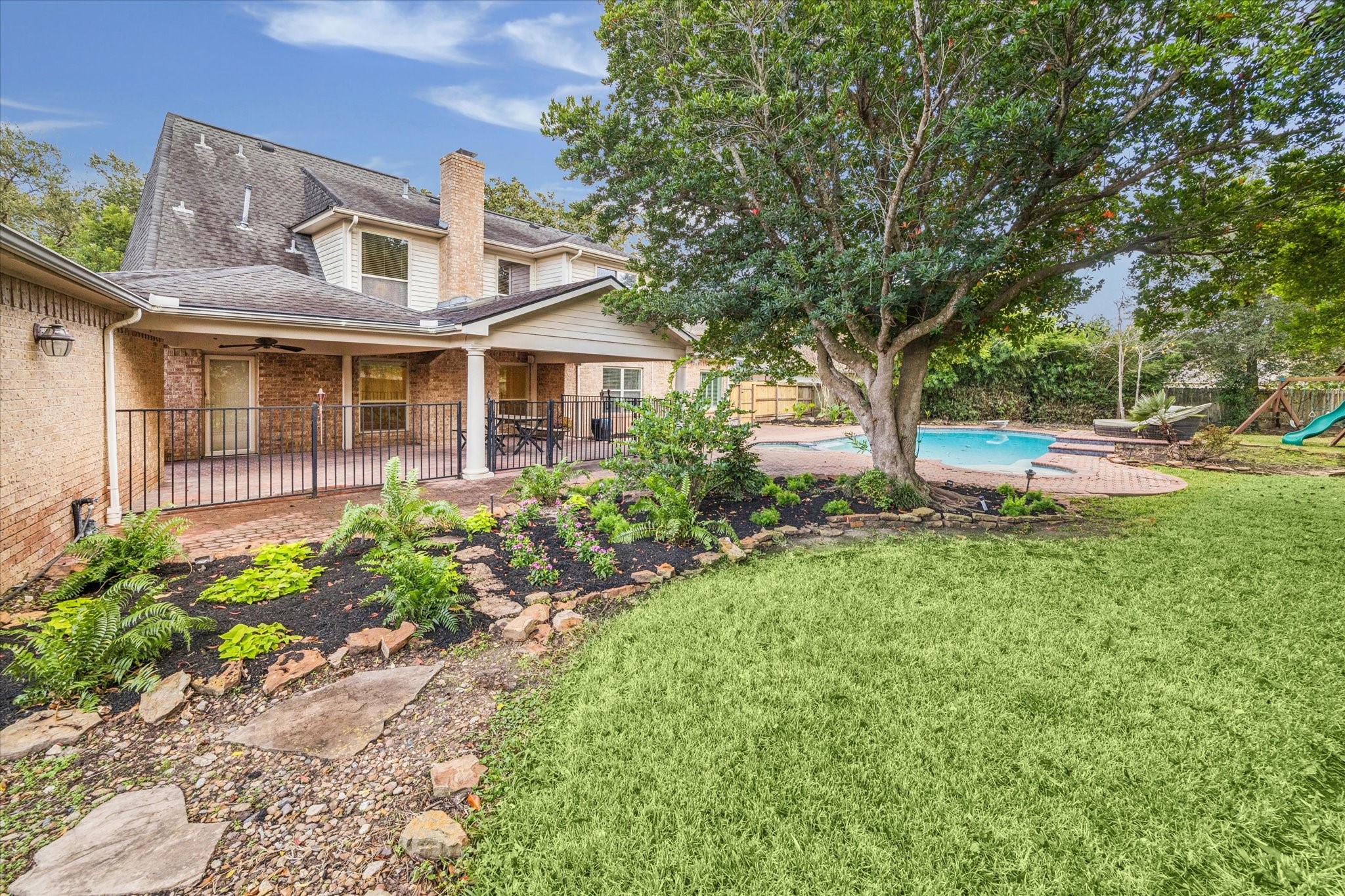 The beautifully upgraded landscape defines this backyard oasis.