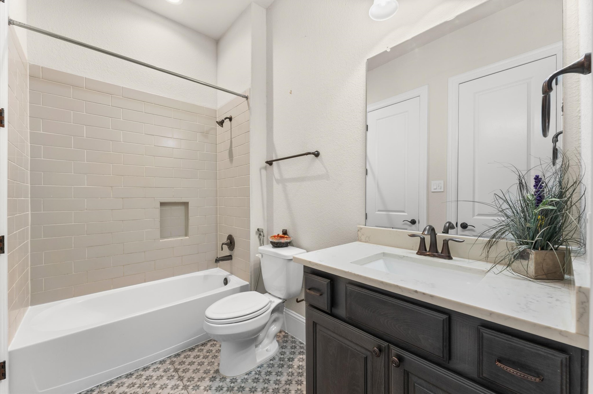 Full bathroom on the first floor with dual access from the bedroom and living area.