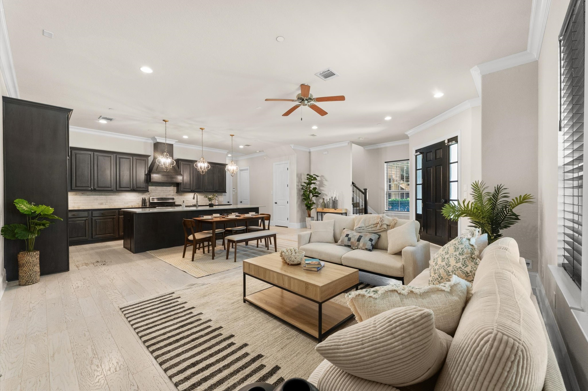 Open-concept living, dining, and kitchen area featuring a seamless flow and modern layout.