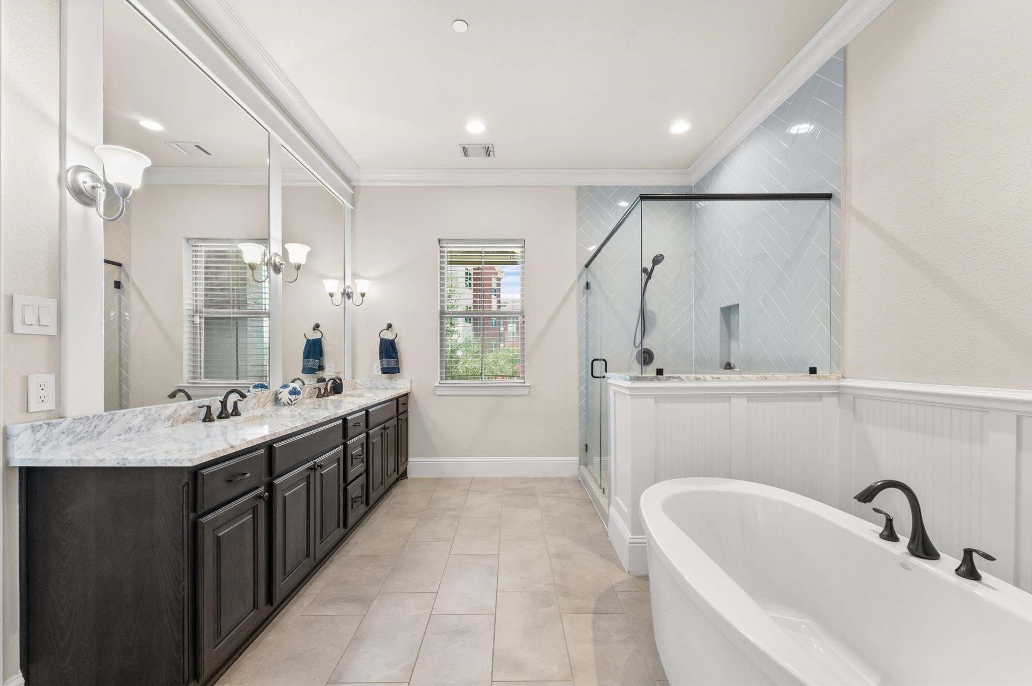 Primary bathroom featuring a dual vanity, Hollywood tub, and separate shower.