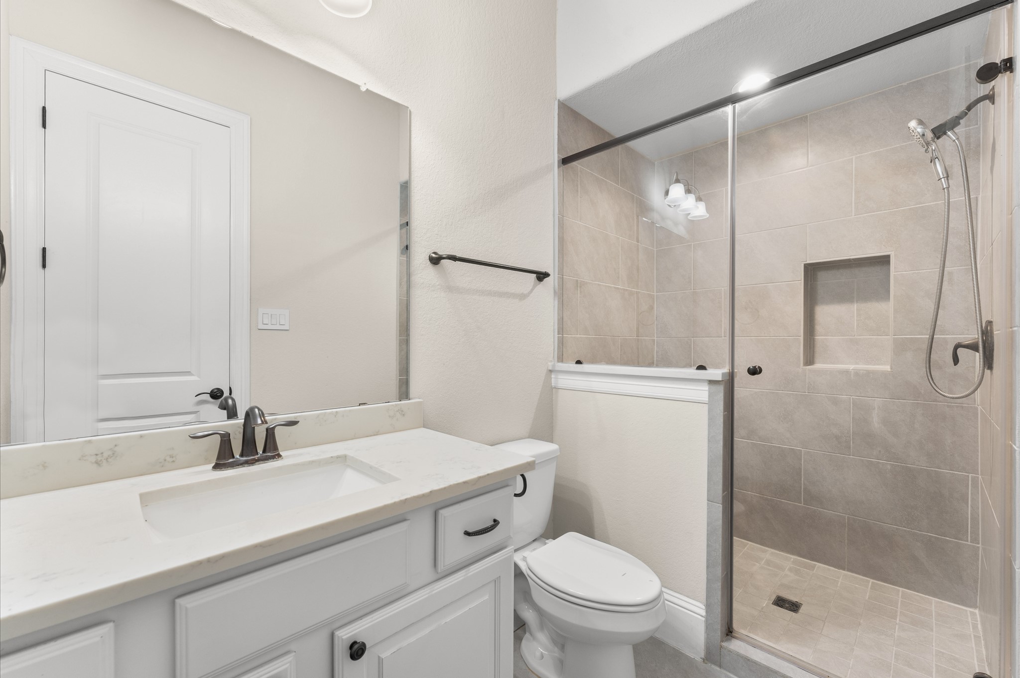 Full bathroom featuring a shower stall with a sliding glass door.