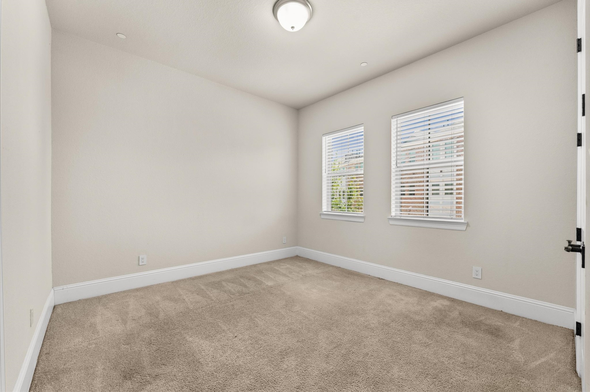 Bedroom 3 featuring updated carpeting.