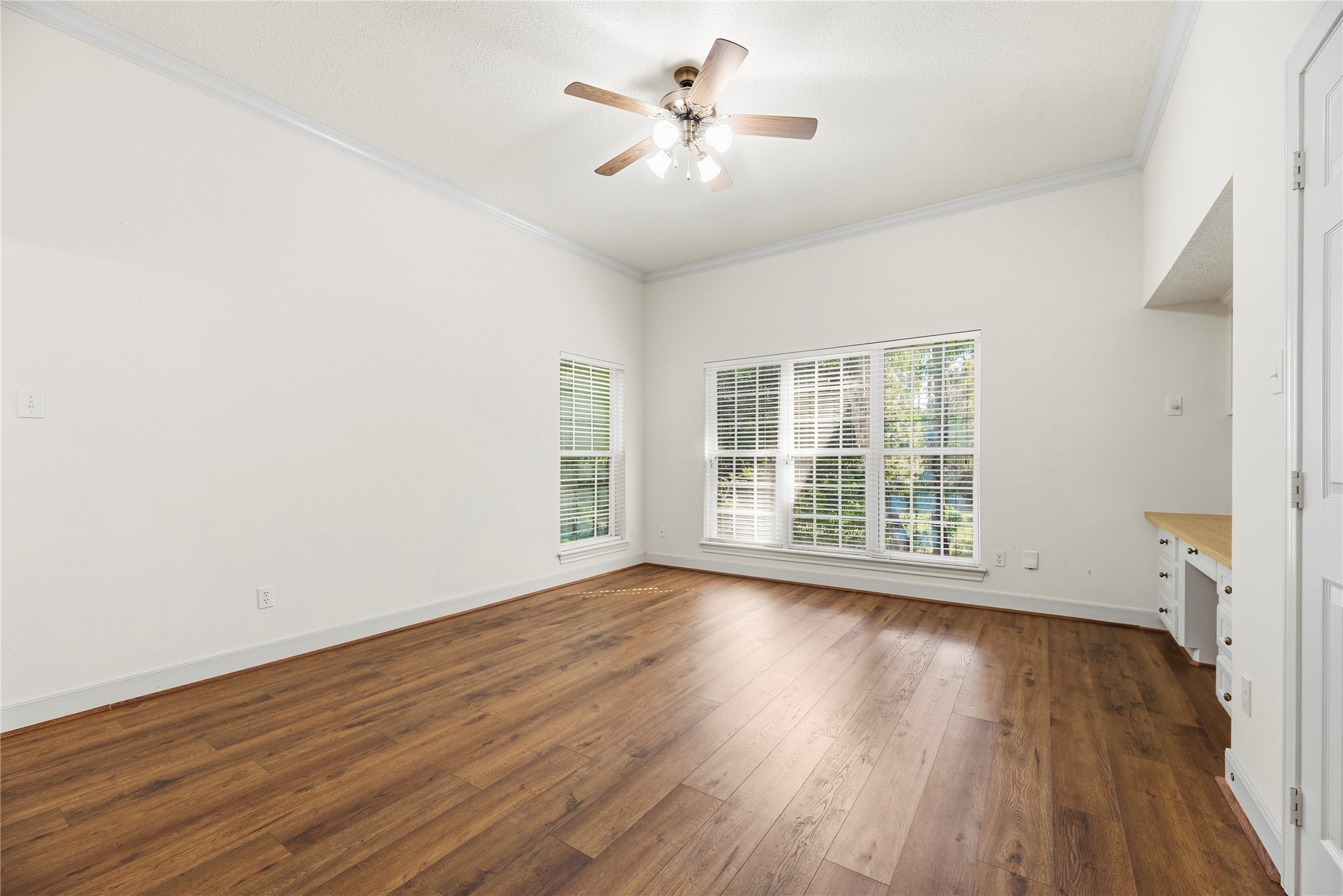 Secondary bedroom offers plenty of natural light and includes built-in desk