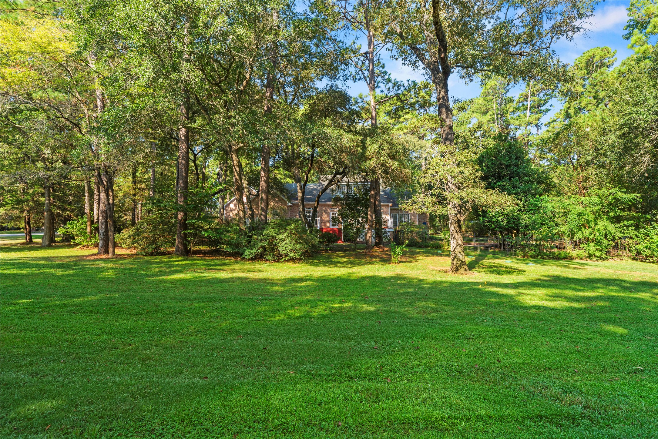 The adjoining second lot adds approximately one acre of open, wooded space, bringing the property to nearly 2 acres total with plenty of room to enjoy, play, garden, or simply spread out.