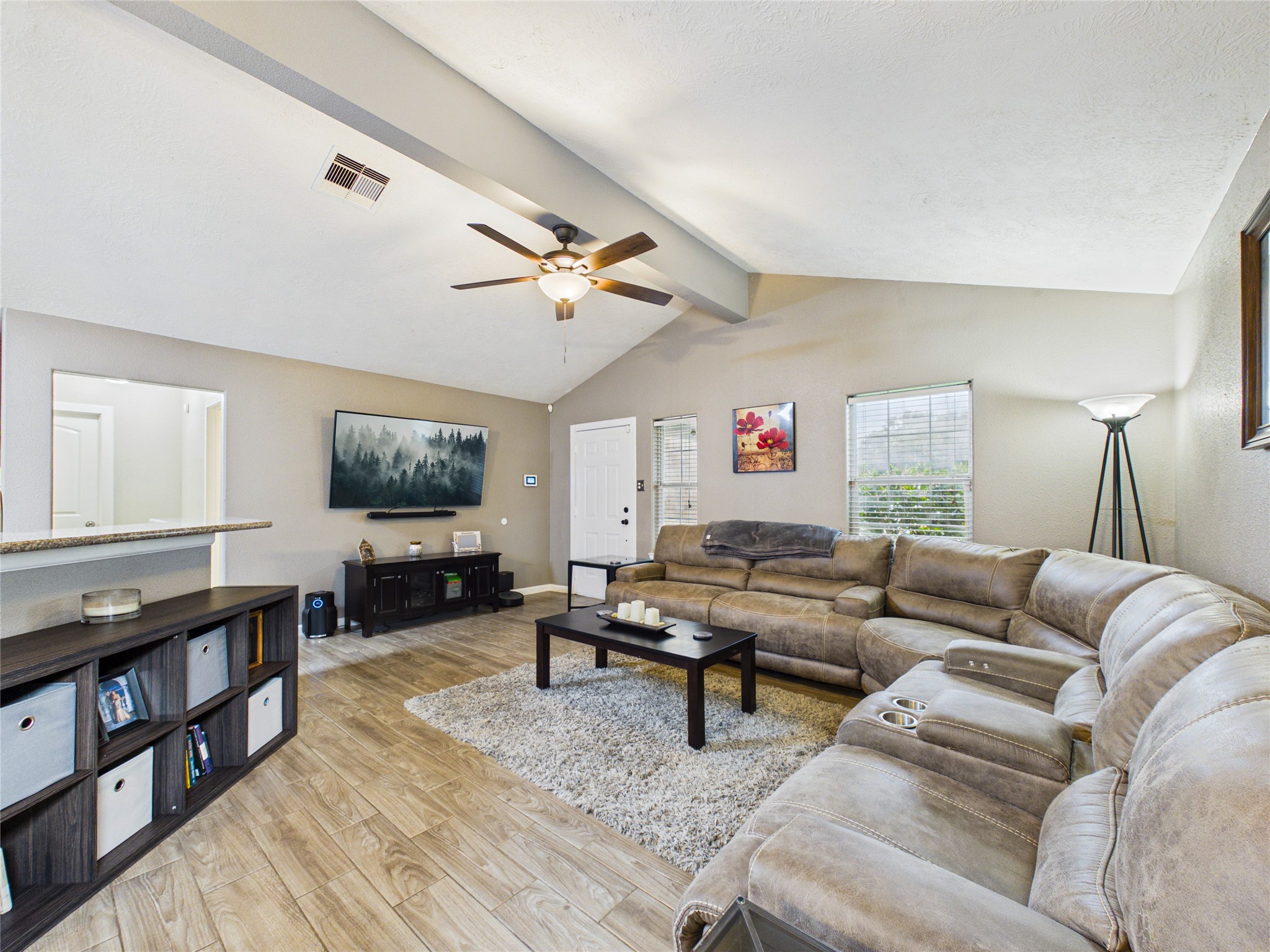 Spacious living room with vaulted ceiling. A view of the front entrance of this well-maintained home. Spacious living room with vaulted ceiling. A view of the front entrance of this well-maintained home.