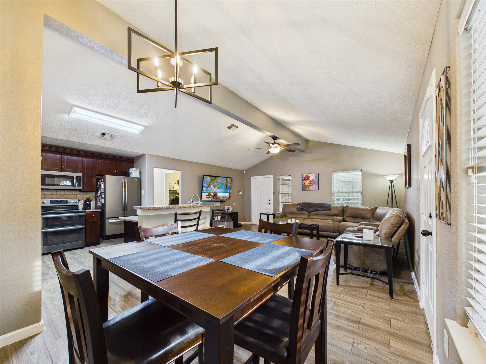 Open-concept dining, kitchen, and living area creates an inviting space perfect for family gatherings and entertaining. Open-concept dining, kitchen, and living area creates an inviting space perfect for family gatherings and entertaining.