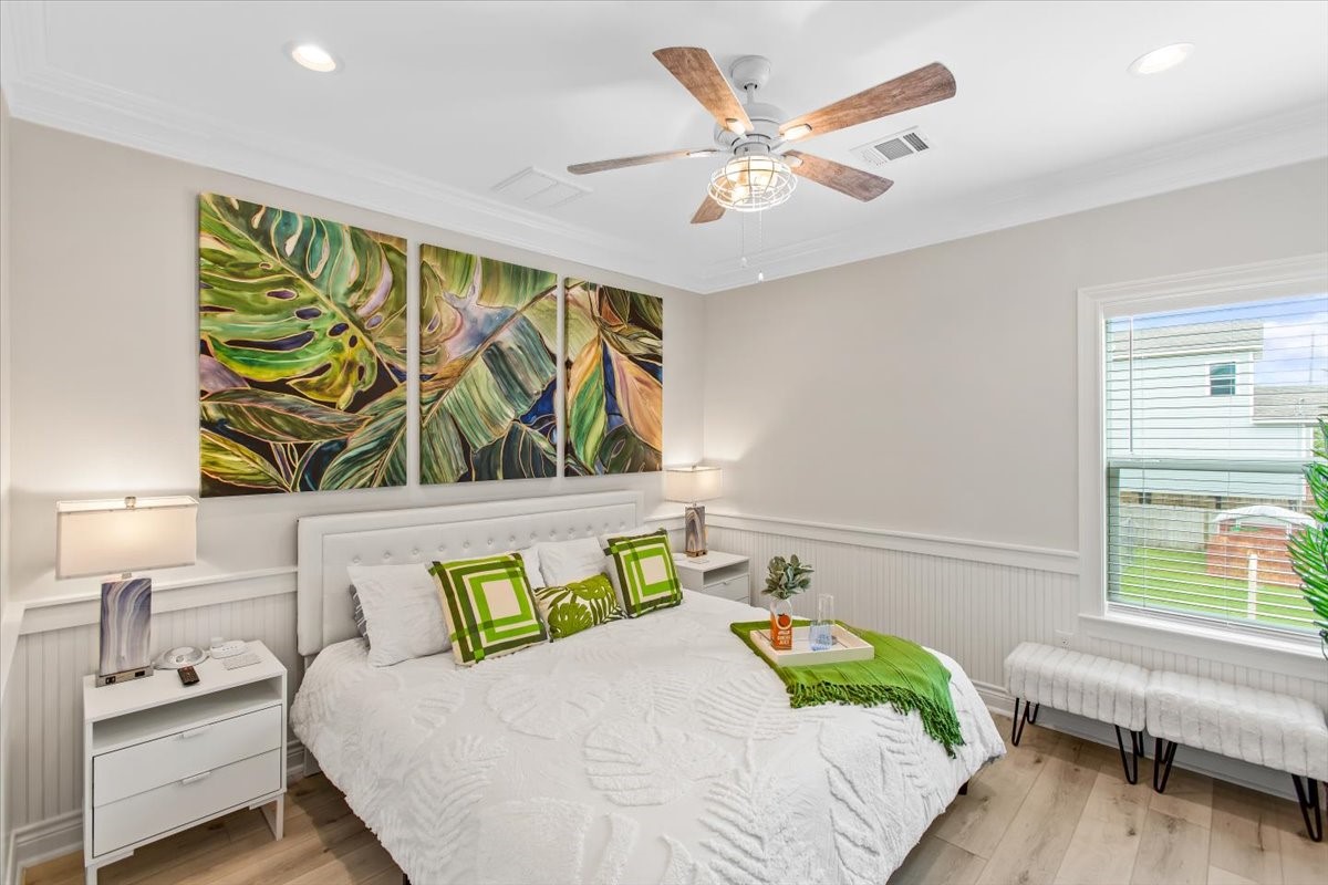 Fist floor primary bedroom with king sized bed. The artwork and accent pieces highlight the room so well!