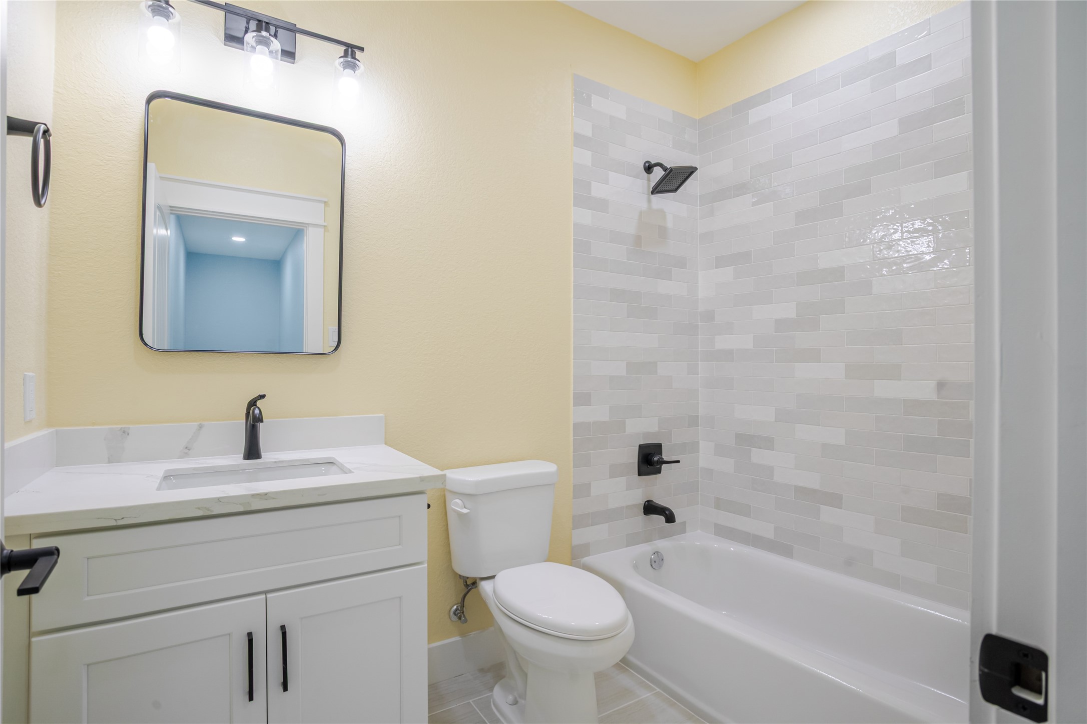 Gorgeous tiled bath and soft coastal color enhance the bath experience!