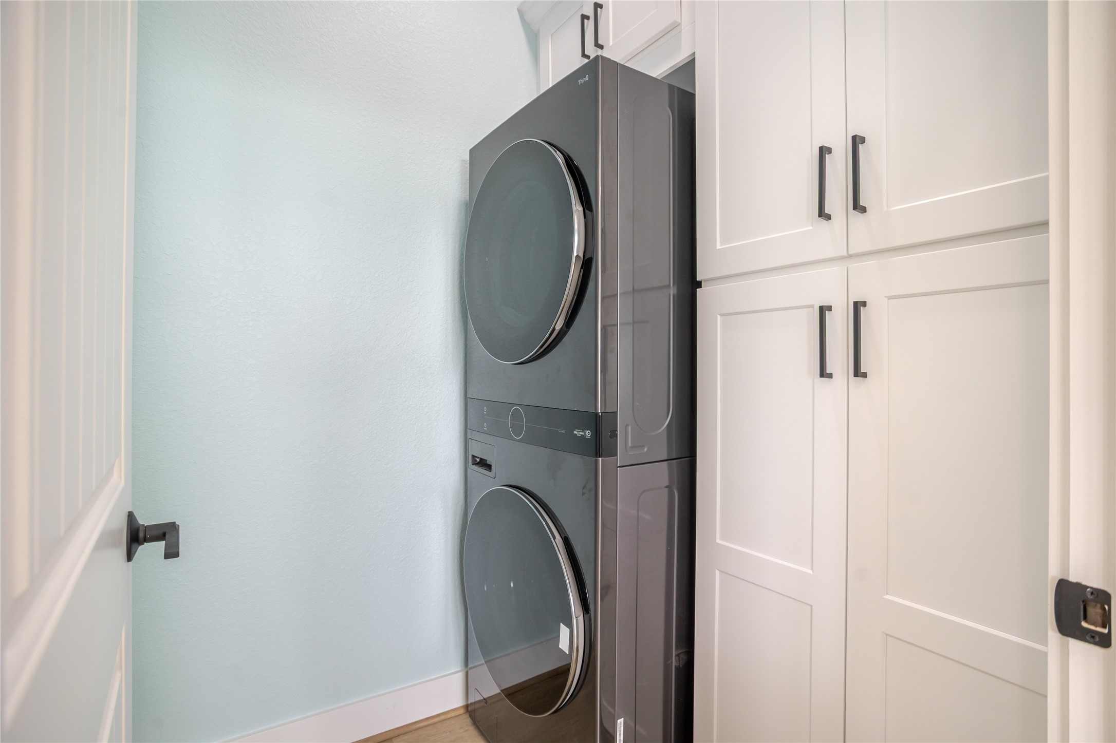 Large double stacked washer and dryer on the main floor with lots of cabinet space