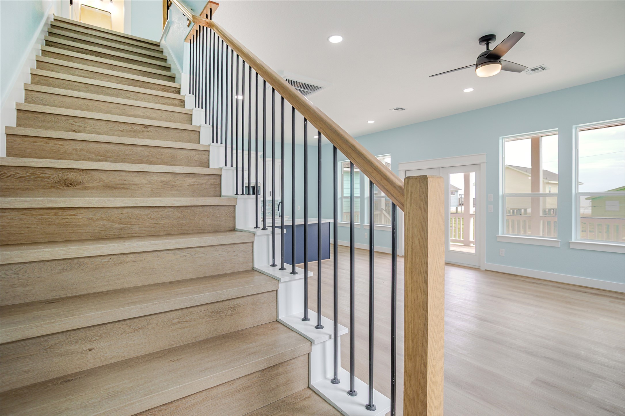 Rod iron meets wood! Beautiful staircase that is engineered to be functional yet a designer look to the home!