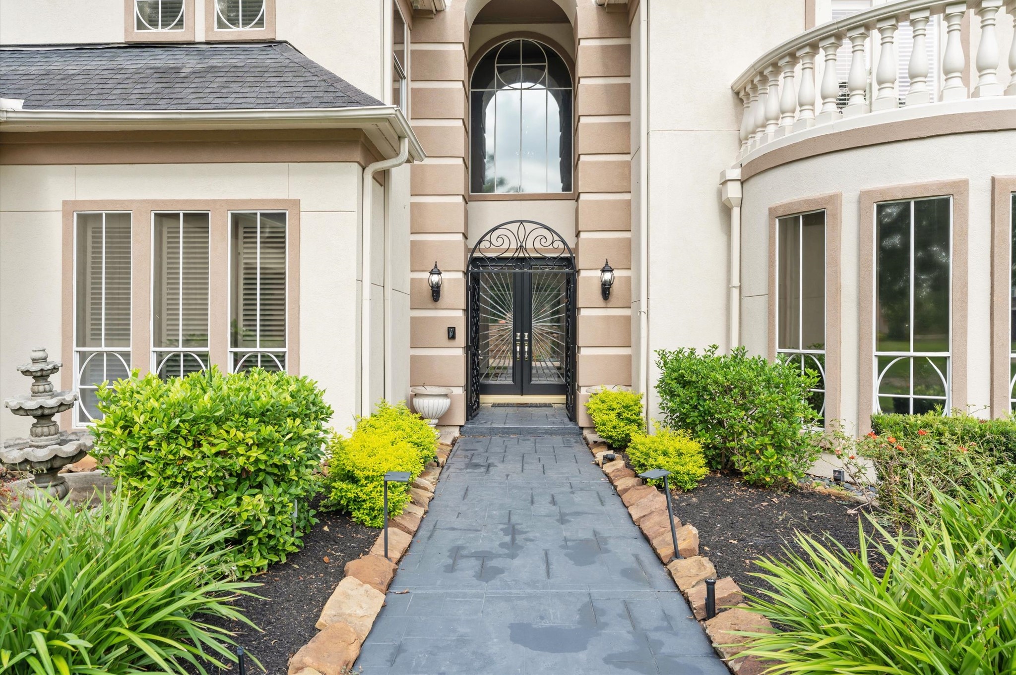 Gorgeous grand entrance your guests with a decorate wrought iron gate.