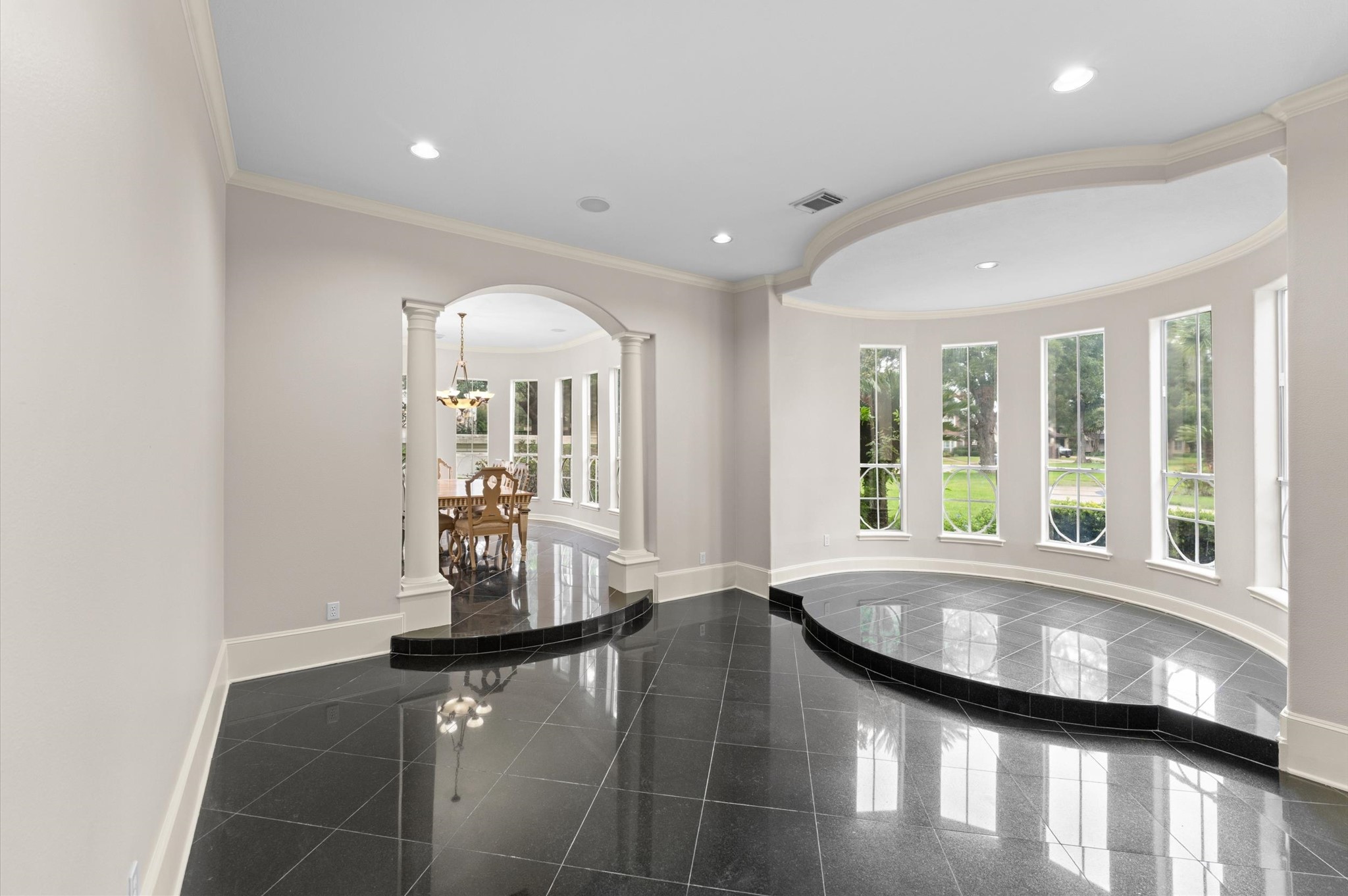 A view into the formal living room has a perfect spot for your baby grand by the wall of windows.