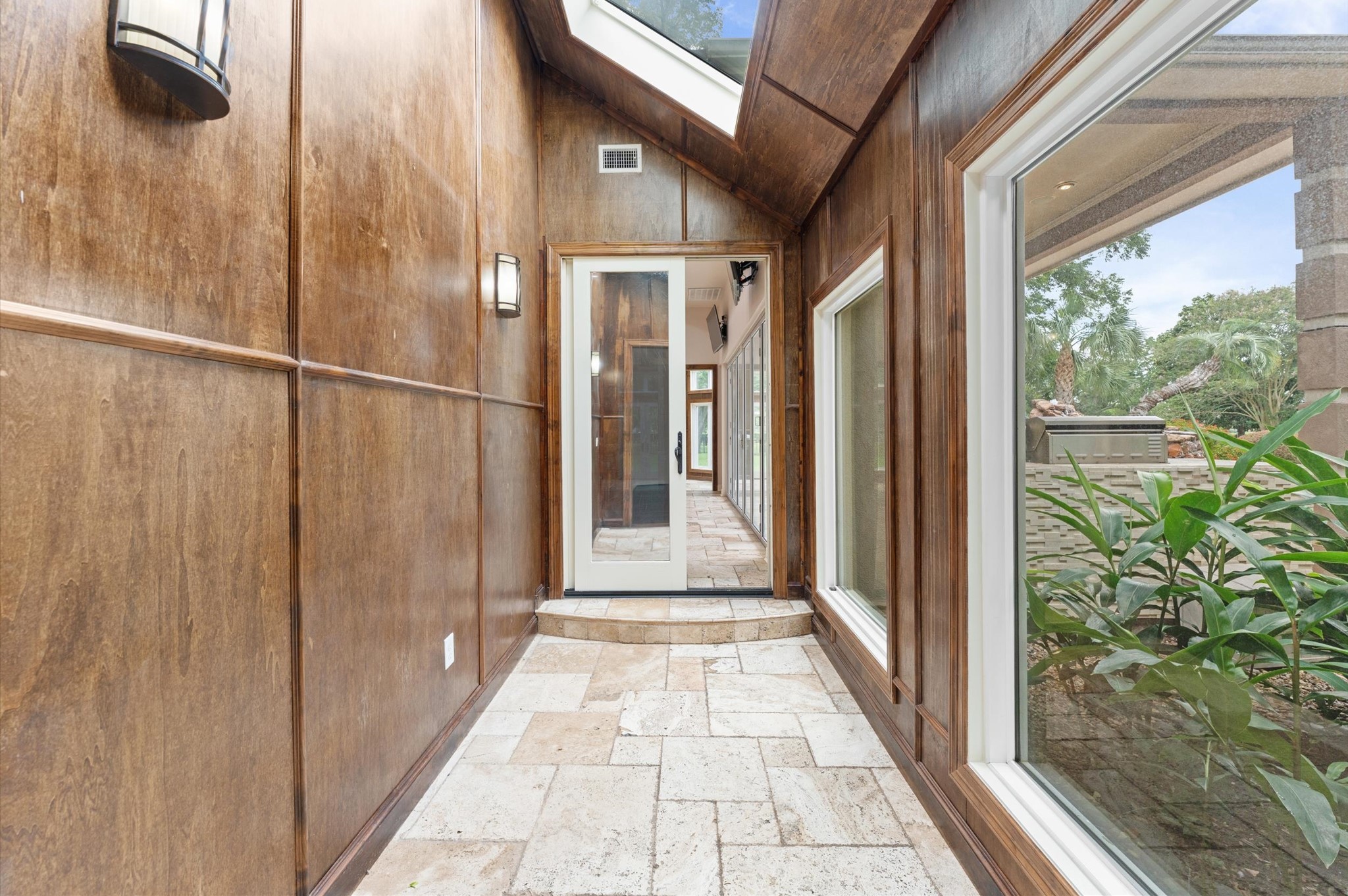 A short walk from primary suite through this hallway is the cabana / sunroom.