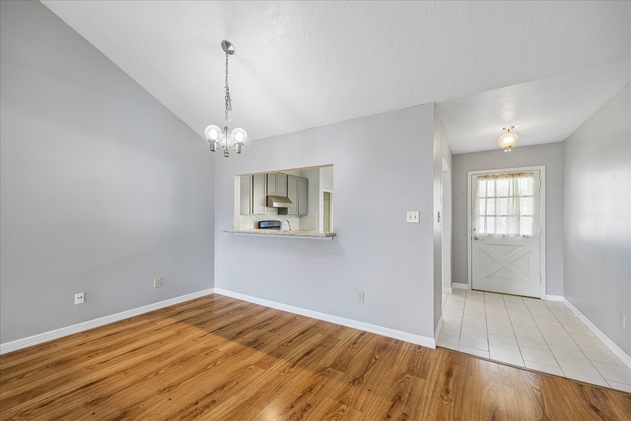 Dedicated dining area sits conveniently between the kitchen and living room, with a pass-through that keeps the spaces visually connected.