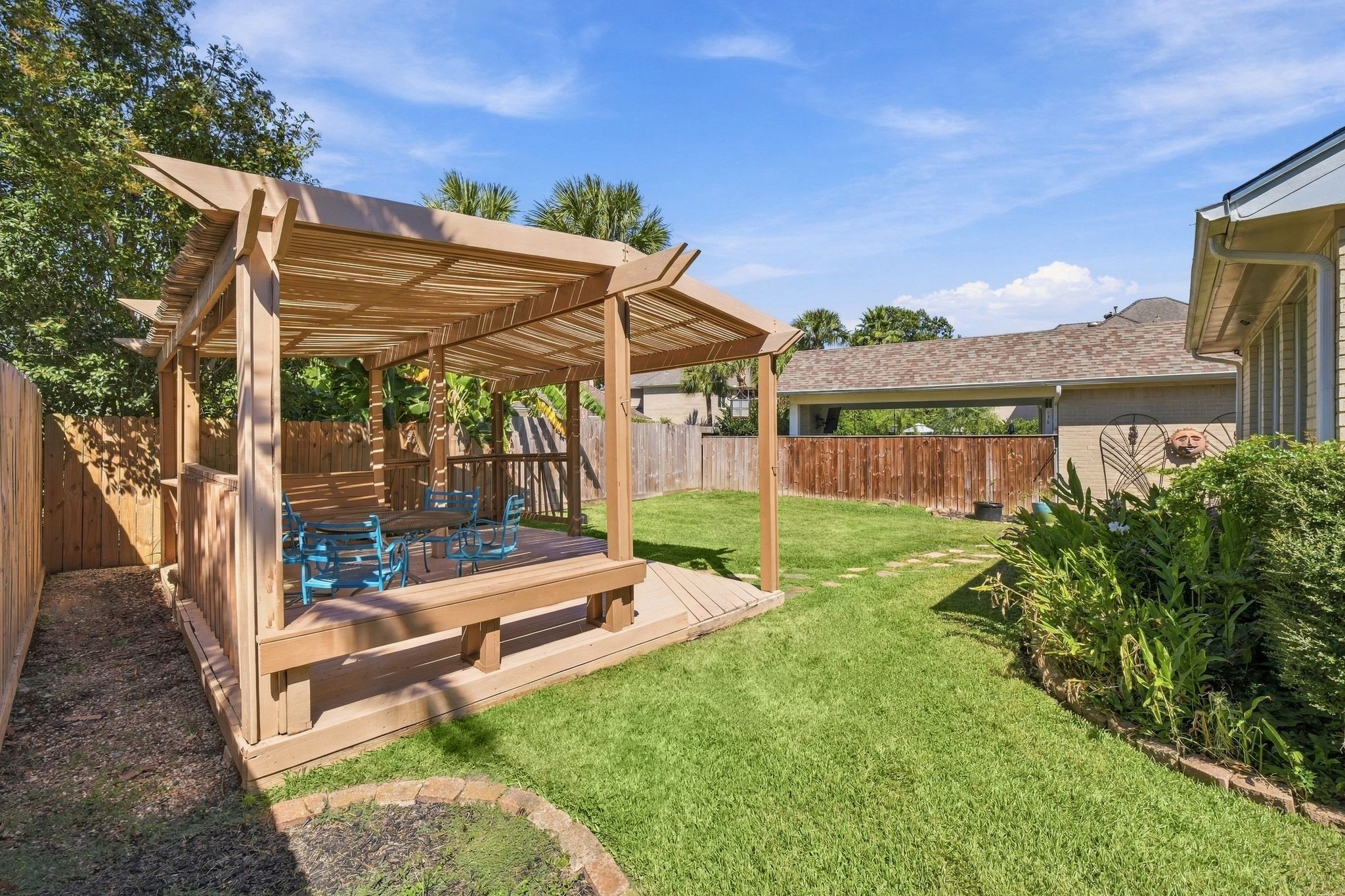 Enjoy outdoor gatherings under the charming pergola in this spacious backyard, perfect for entertaining and giving your furry friend plenty of room to play.