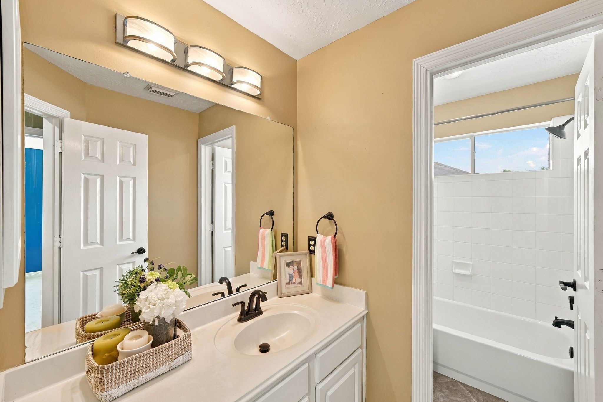 Experience comfort and style in the second upstairs bath, featuring a convenient tub/shower combo and elegant design touches.