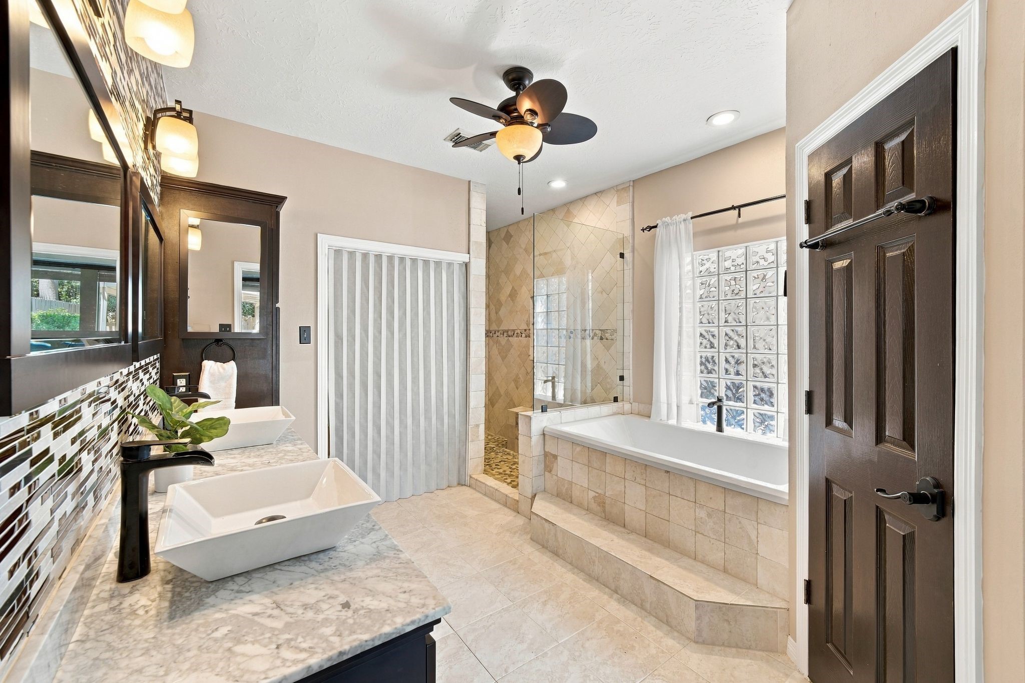Unwind in a luxurious bathroom oasis, featuring a spacious tub perfect for relaxing after a long day.