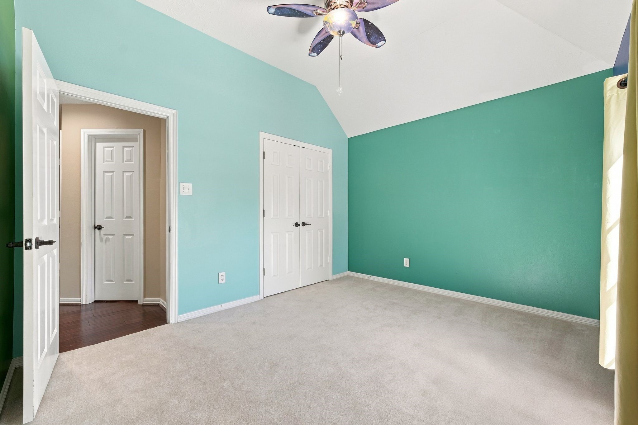 Discover a bright, inviting room with high ceilings and fresh, vibrant walls, ready for your personal touch.