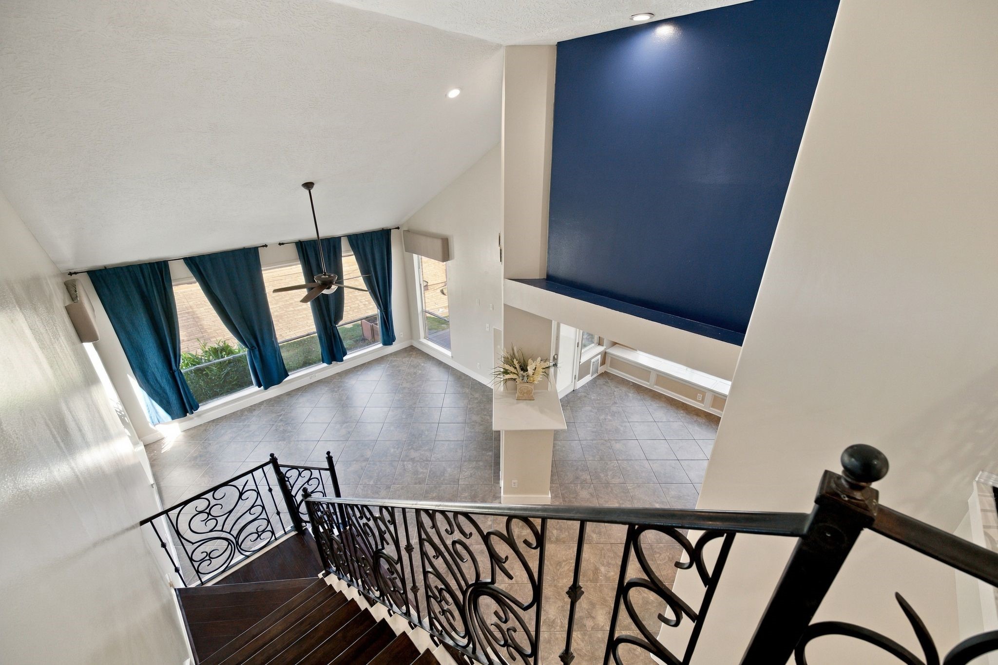 Ascend to the second floor to enjoy a stunning bird's-eye view of the spacious living and breakfast rooms, highlighted by elegant railings and abundant natural light.