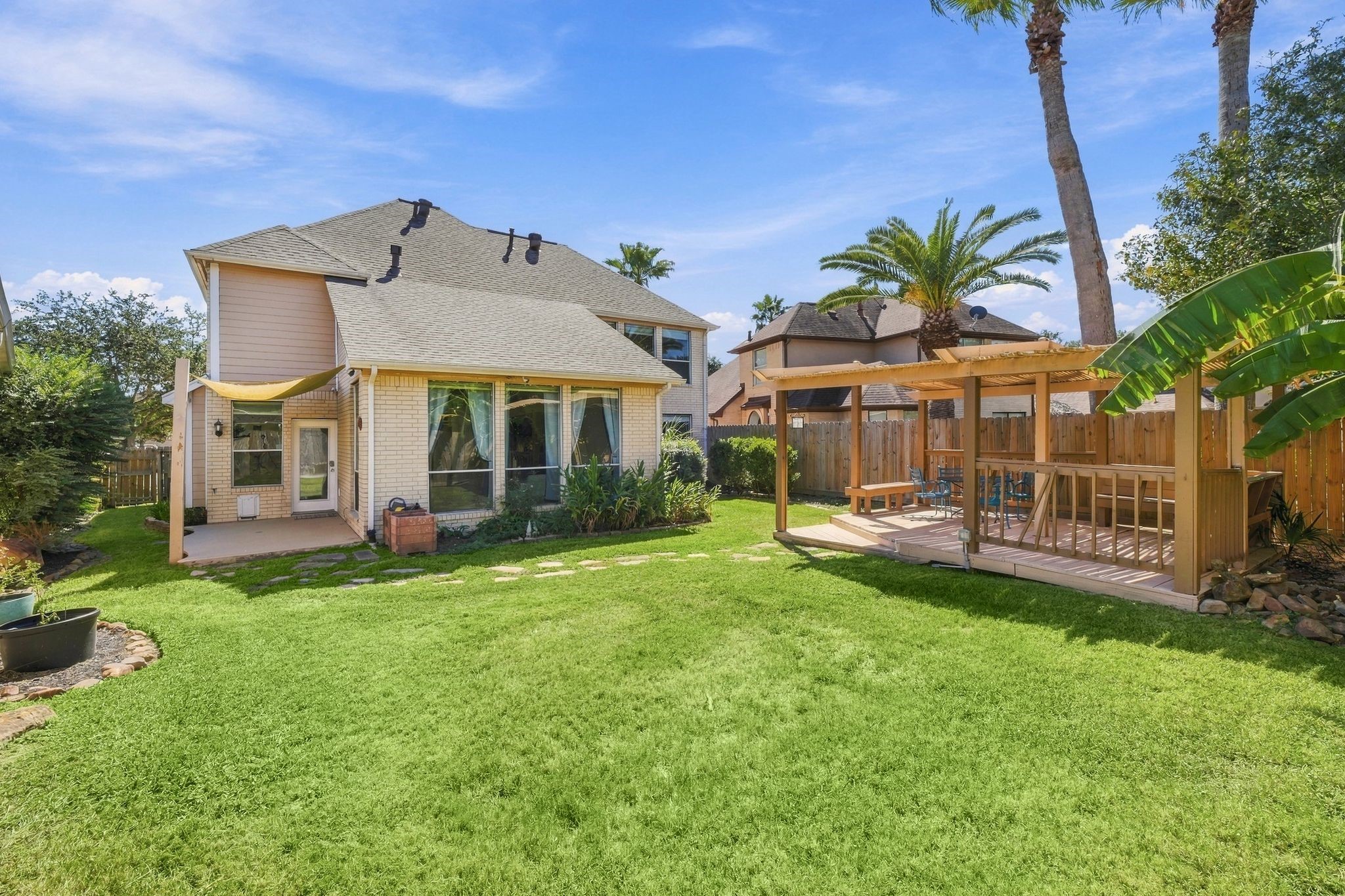 Expansive backyard with a spacious pergola offers endless opportunities for family fun and relaxation.