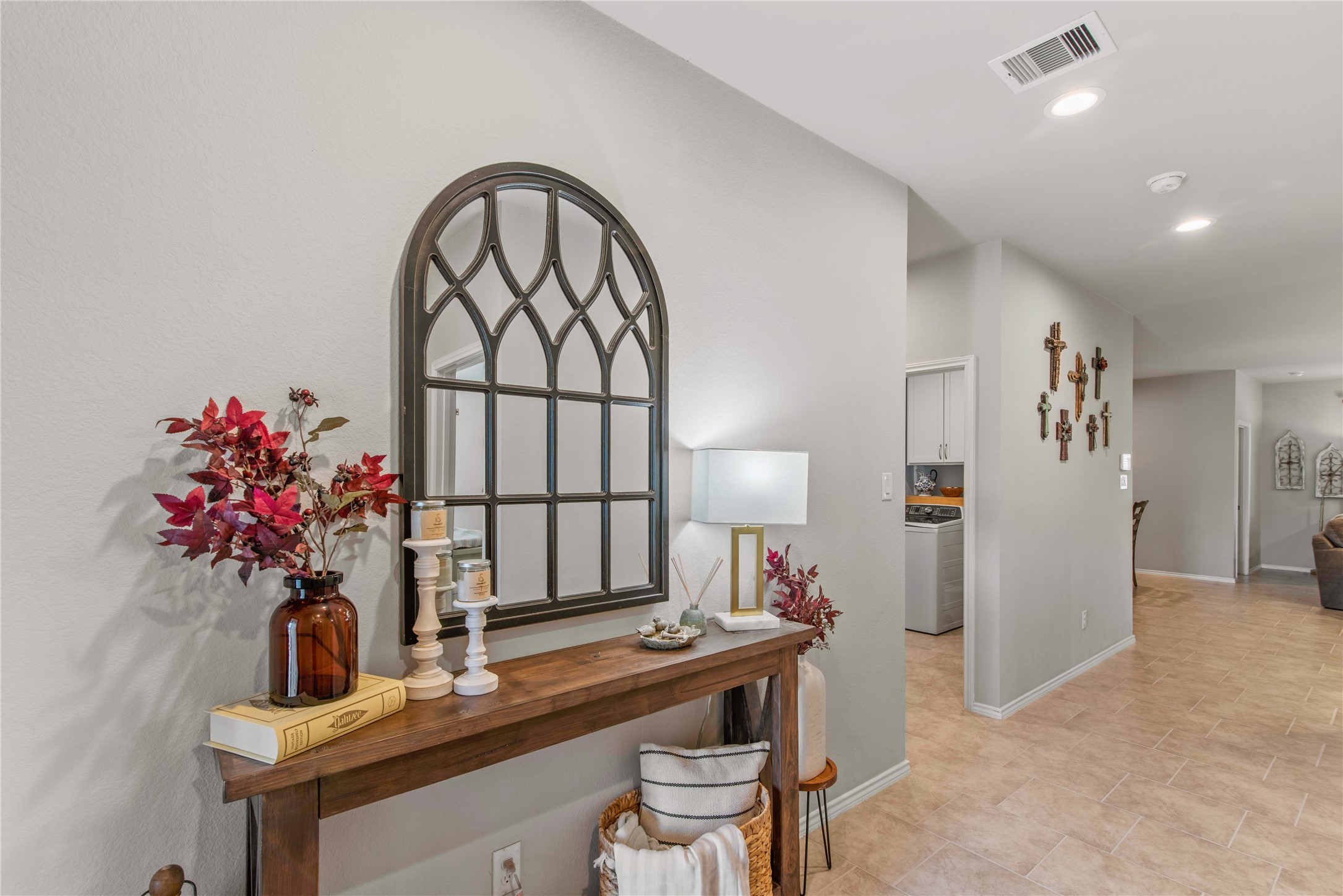 Charming entryway with a decorative mirror and stylish console table, offering a warm and inviting first impression.