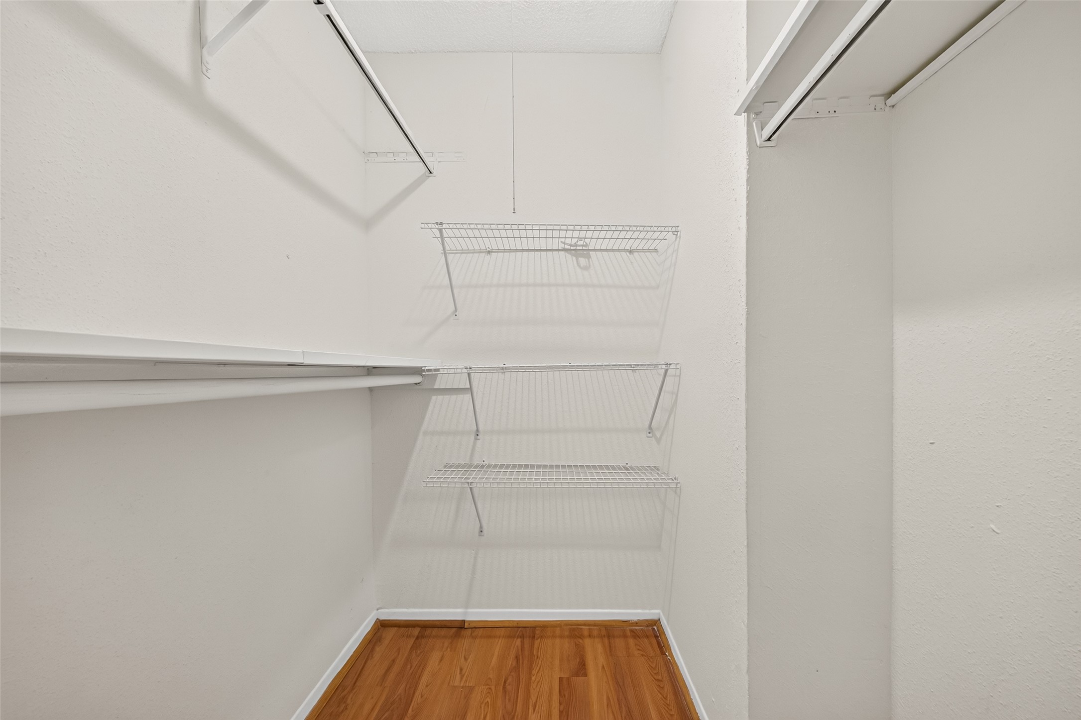 Spacious walk-in closet and ample hanging space for organized storage.