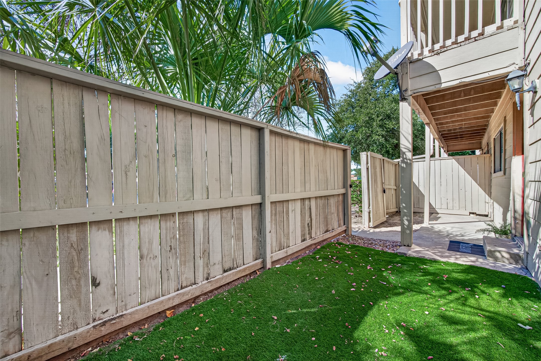 fully fenced front porch  artificial turf for added convenience, easy maintenance, and a clean, inviting outdoor space.