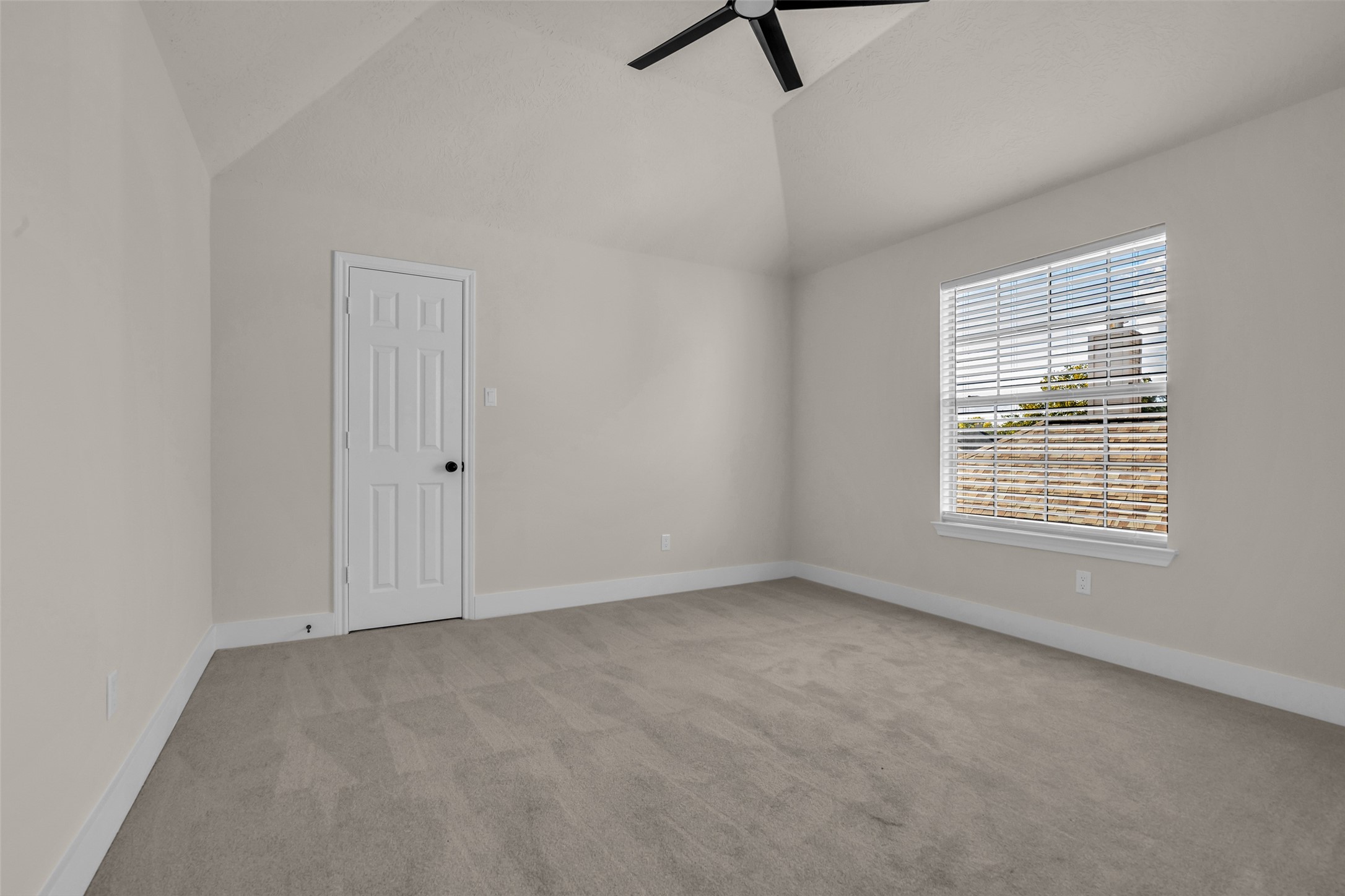 Fourth bedroom featuring vaulted ceilings, a large window for natural light,