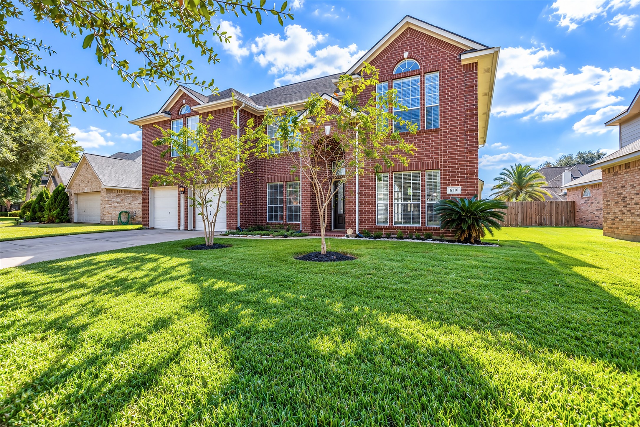 Welcome home! Your two-story brick home with large windows, manicured lawn, and a spacious driveway, offering great curb appeal in a serene neighborhood setting!
