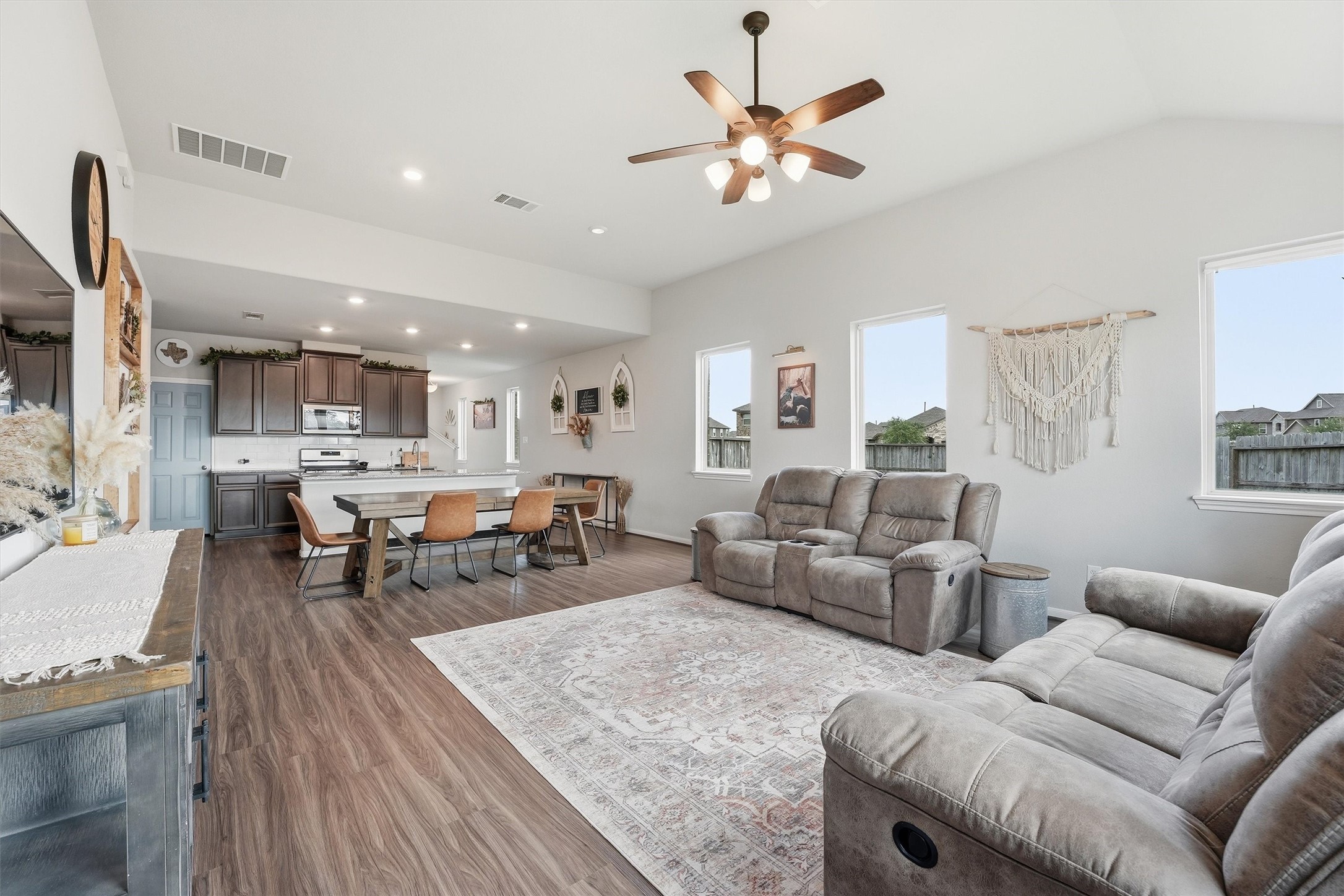 The living room is cozy with plush seating and natural light from large windows. The neutral tones a create a warm, inviting atmosphere. The living room is cozy with plush seating and natural light from large windows. The neutral tones a create a warm, inviting atmosphere.