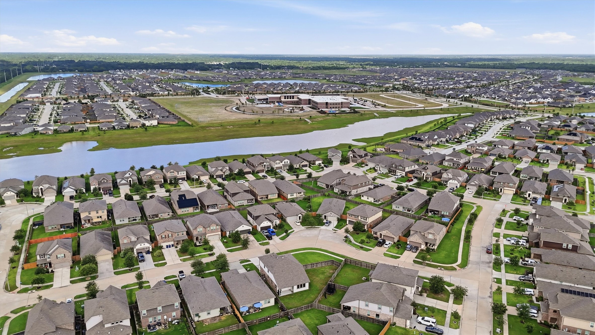Aerial photo showcasing a portion of Lago Mar. A scenic waterway and community facilities are visible, offering a serene living environment.
