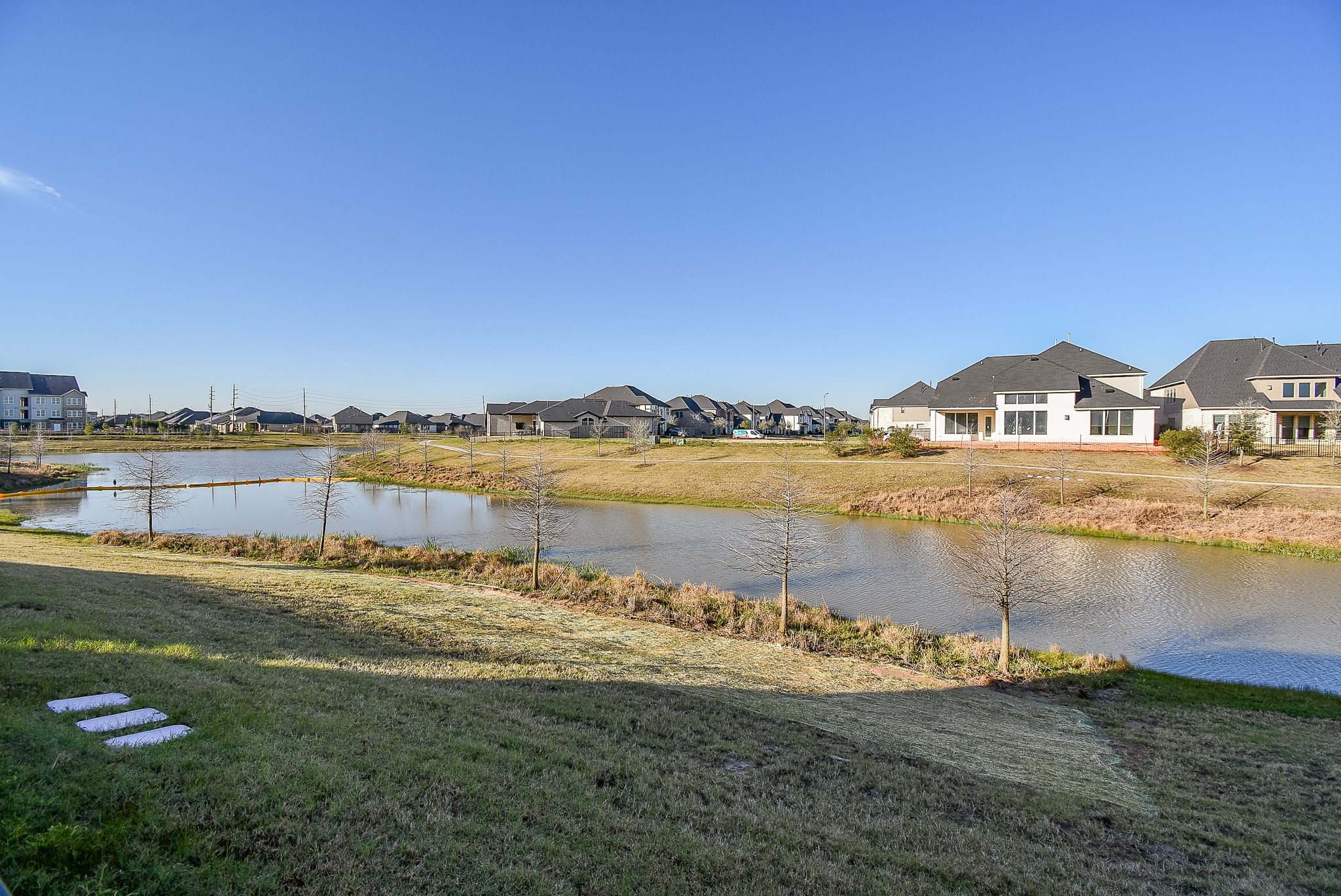 A larger beautiful water view of the community and a lake.
