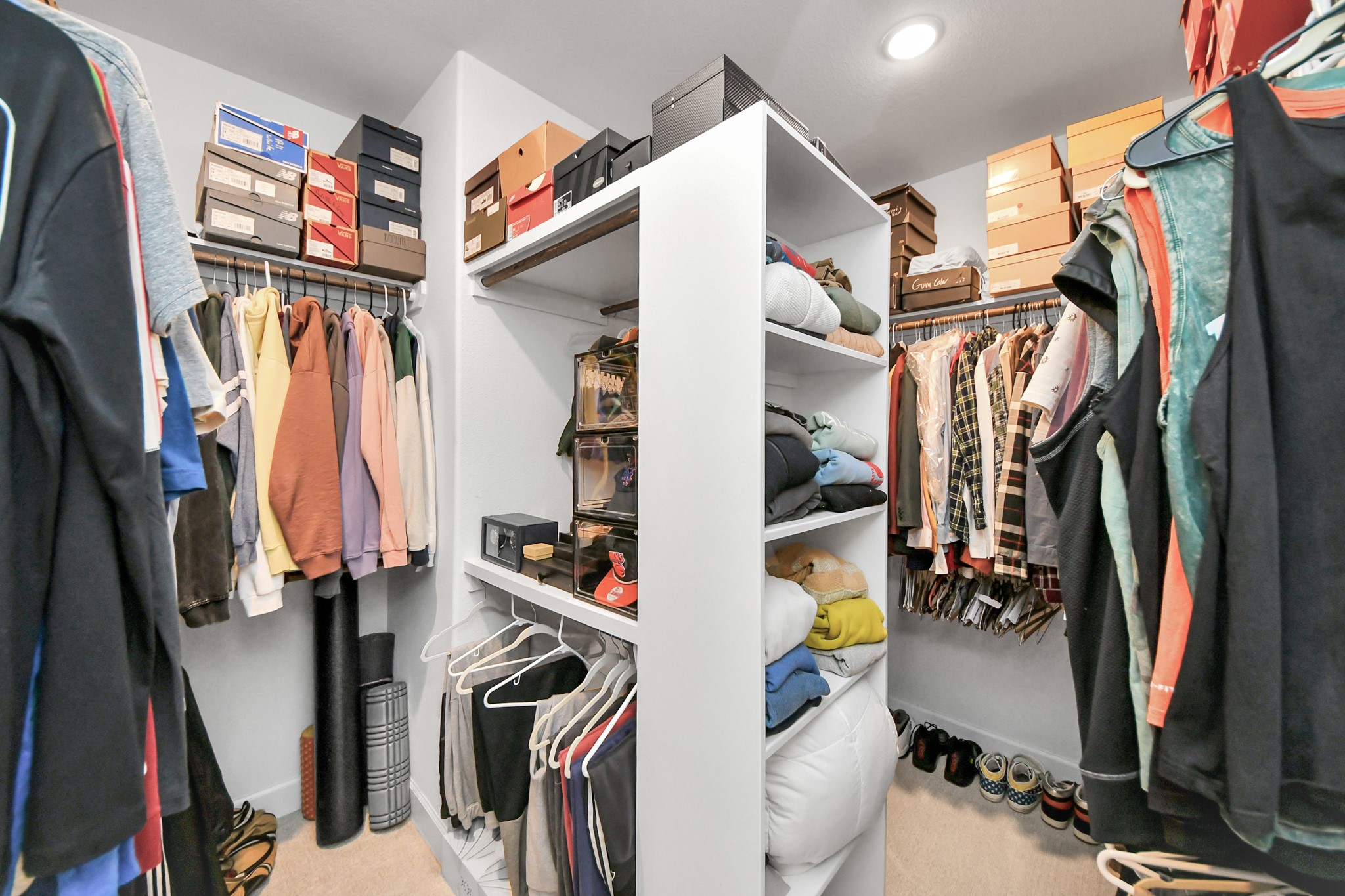 Spacious walk-in closet with ample shelving and hanging space, perfect for organizing clothes and shoes.