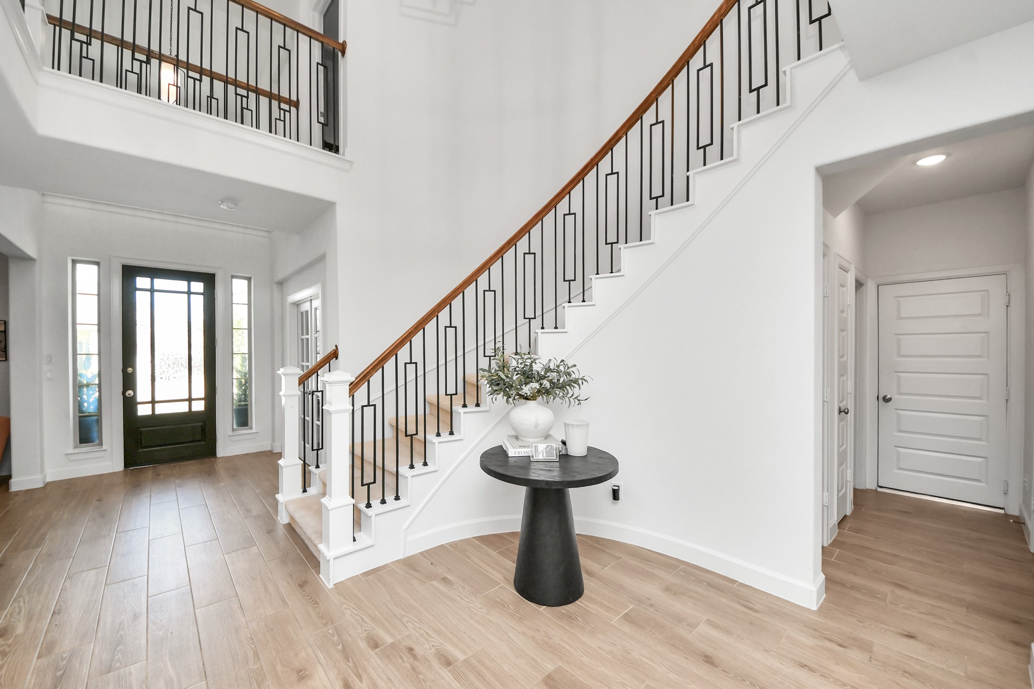 Great location to put your Christmas tree. Stunning two-story foyer with elegant wood and iron staircase, complemented by sleek hardwood floors and abundant natural light.