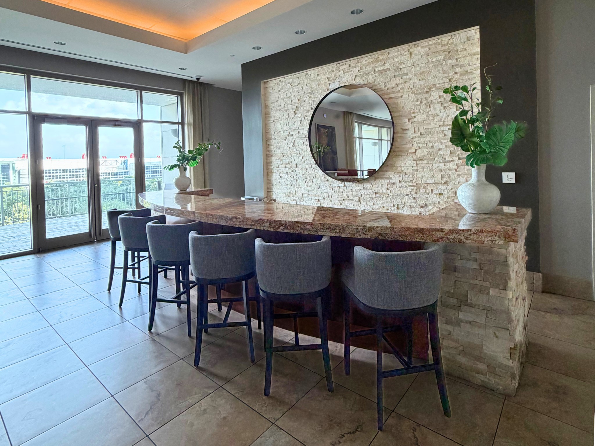 Designed for entertaining, the elegant resident lounge features a stylish bar area perfect for hosting private gatherings, celebrations or social events. Just beyond, the expansive outdoor terrace offers sweeping views of Discovery Green and Houston's iconic skyline, creating an unforgettable setting for residents and guests alike.
